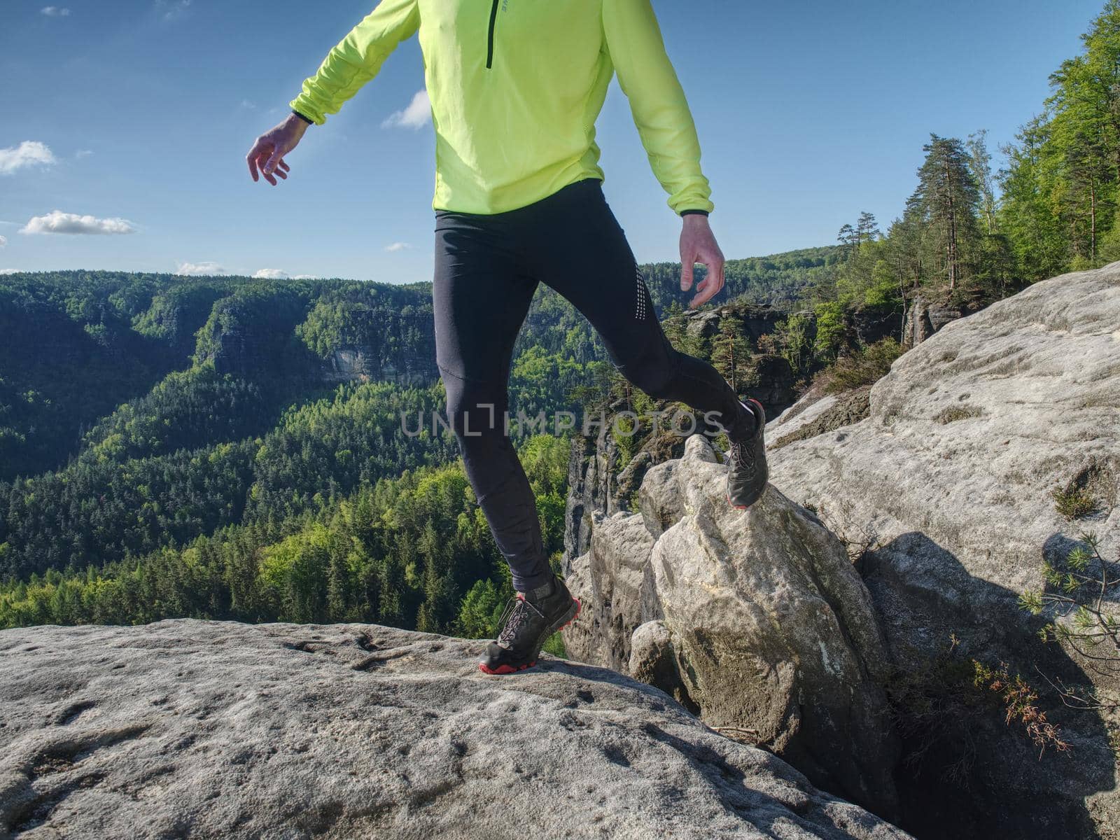 Man runner body and shadow on sandstone rock. Running man body within mountain trail