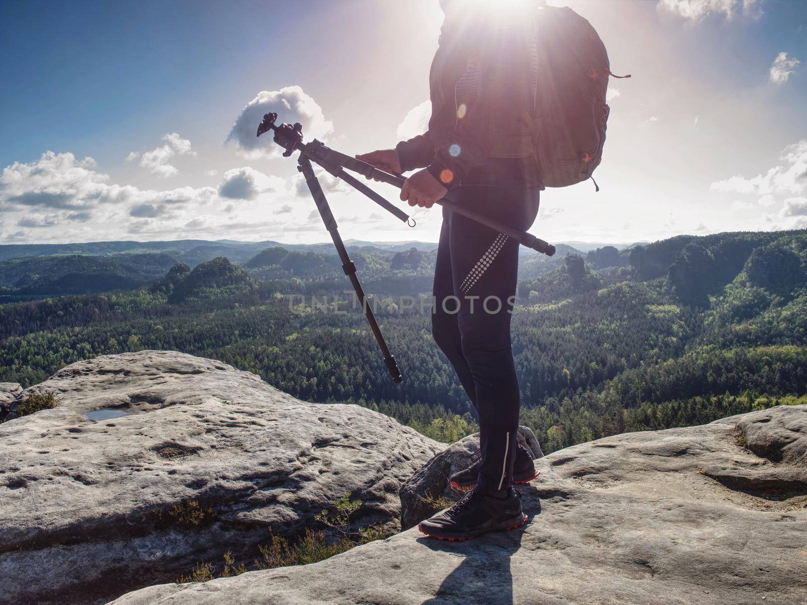 Travel photographer on mountain summit works. Man like to travel and photography taking pictures of moments during autumn 