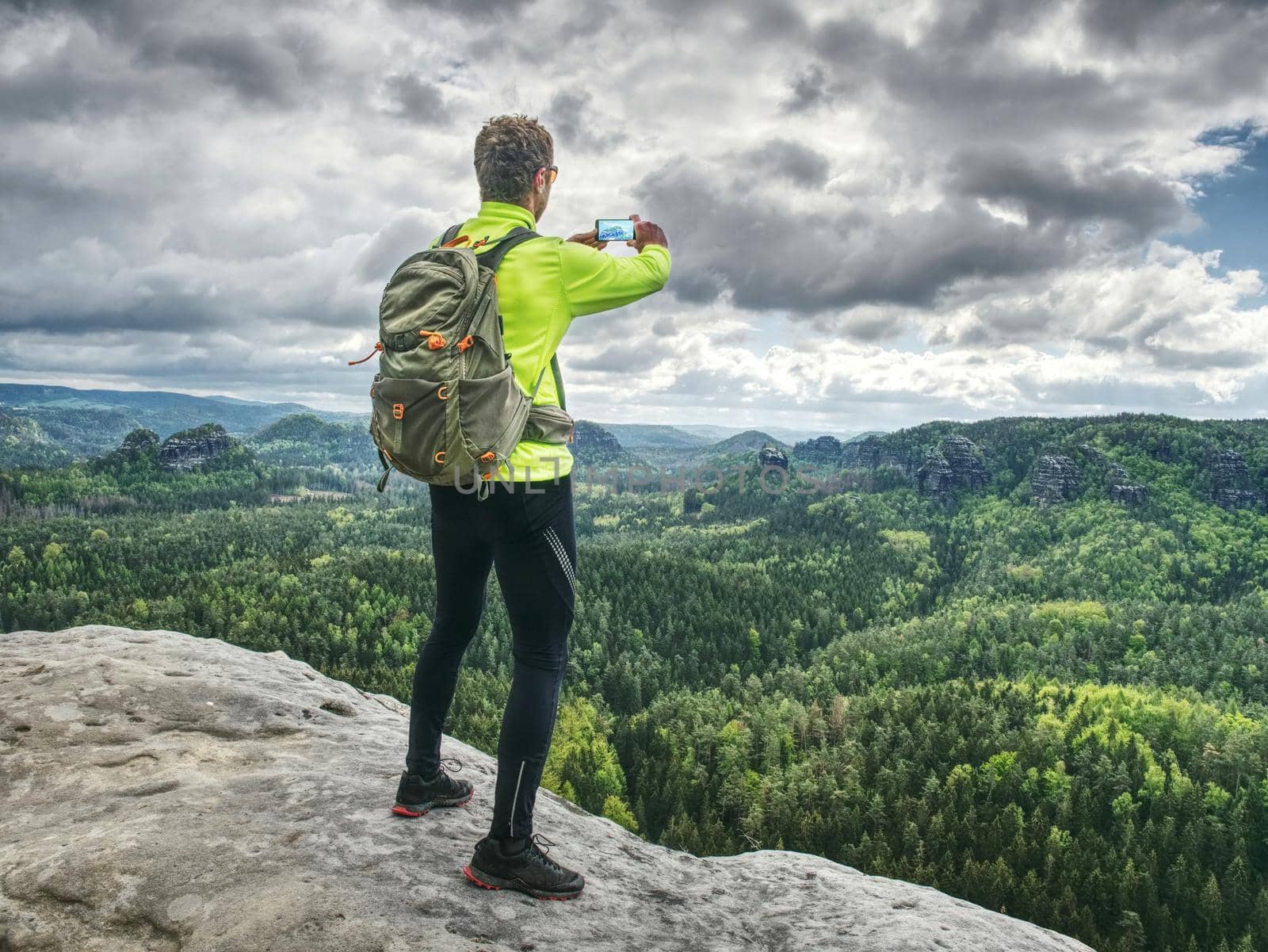 Trail runner takes rest, makes photos by his smart phone.  by rdonar2