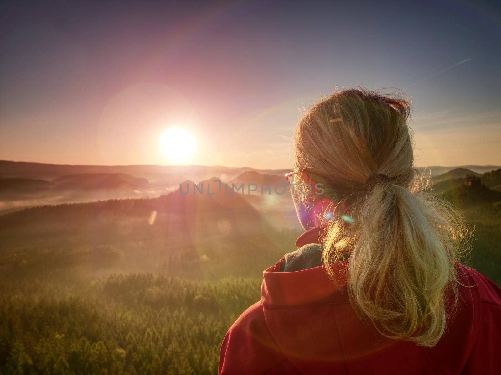 Beautiful blonde girl on background of morning mountains by rdonar2