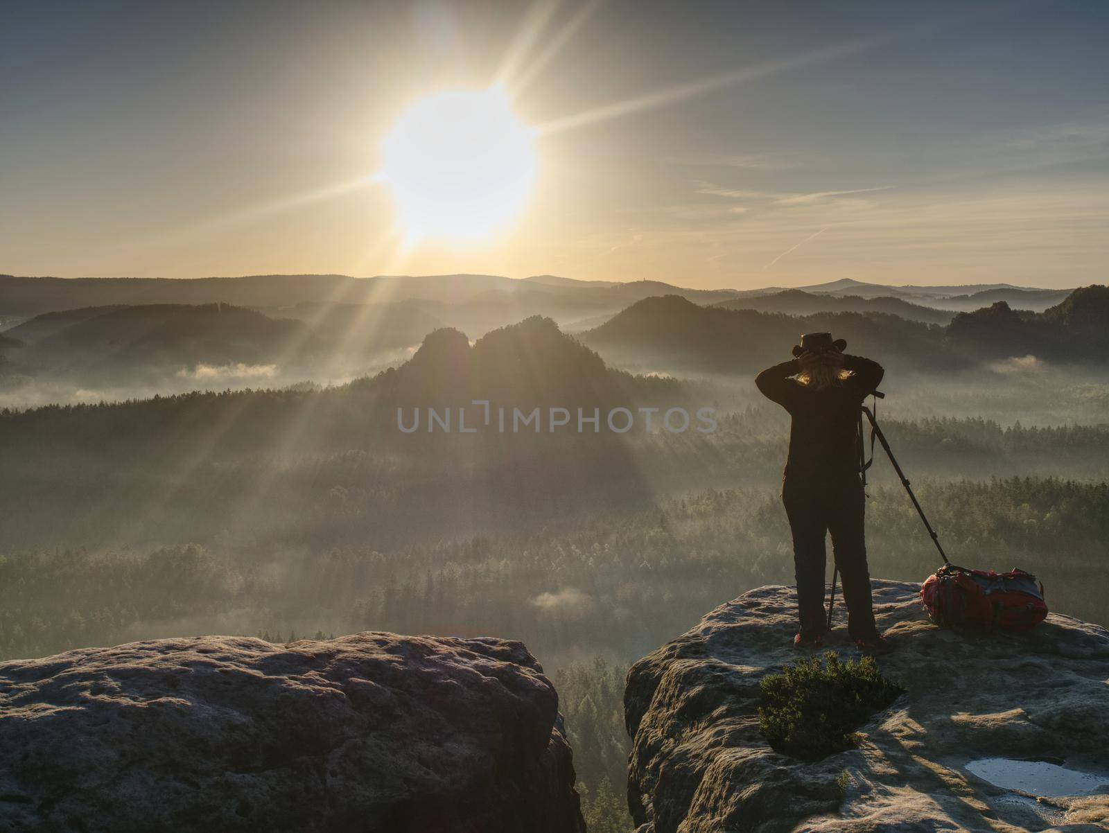 Girl frind photographer artist working on the edge. View point on high mountain peak with circle view around. 