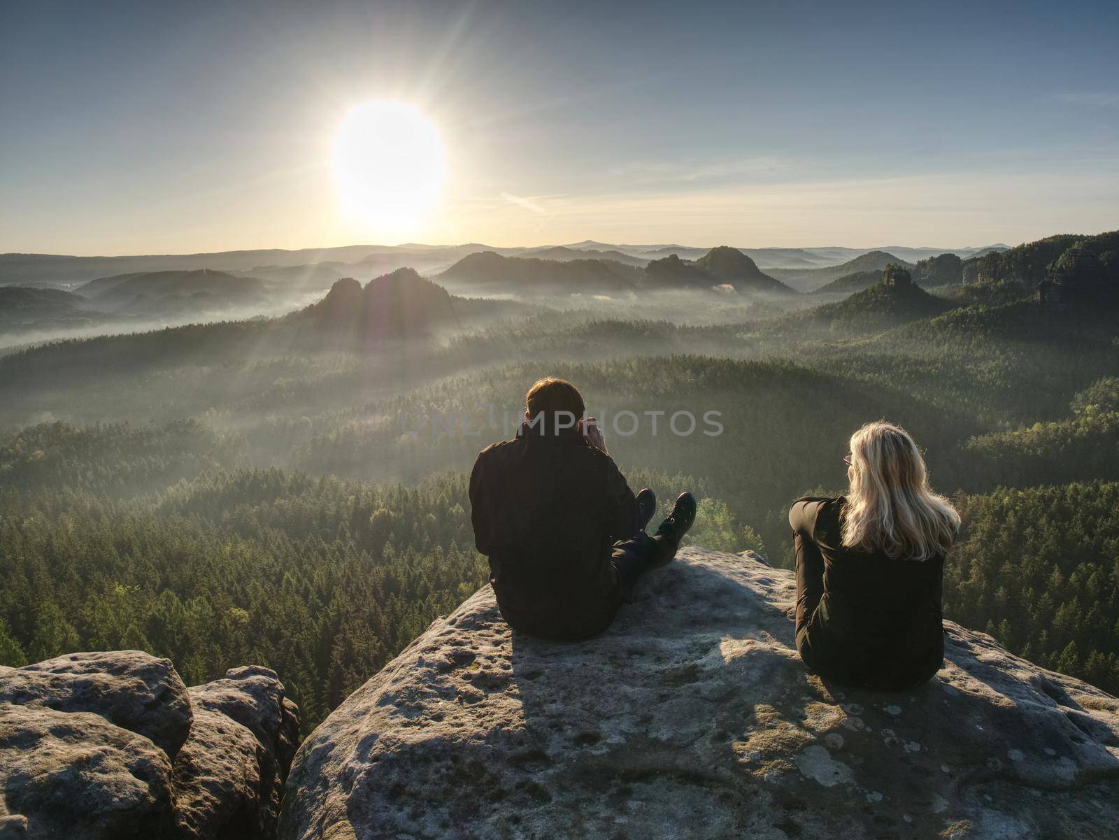 Two photographers discuss and share my experiences. Artists make amazing photos on a ledge above the daybreak pure nature.