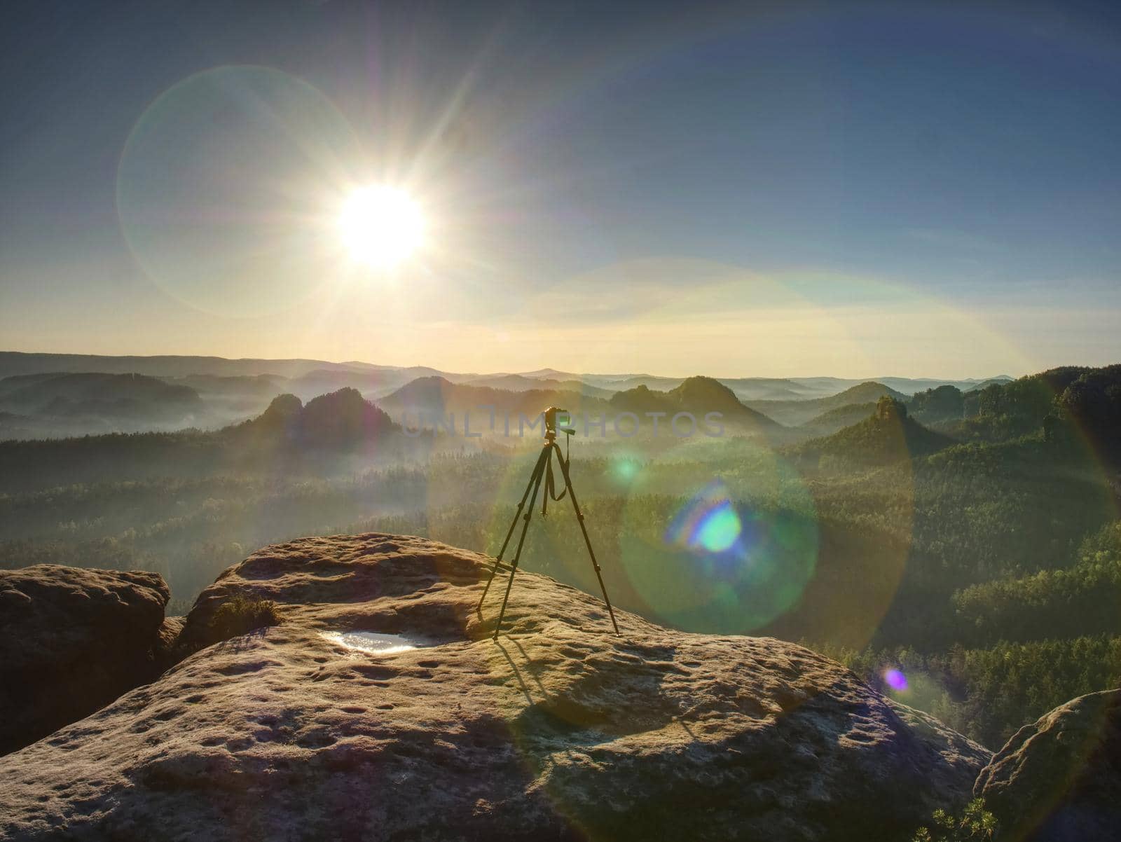 Digital photo camera with tripod  record video during sunrise  by rdonar2