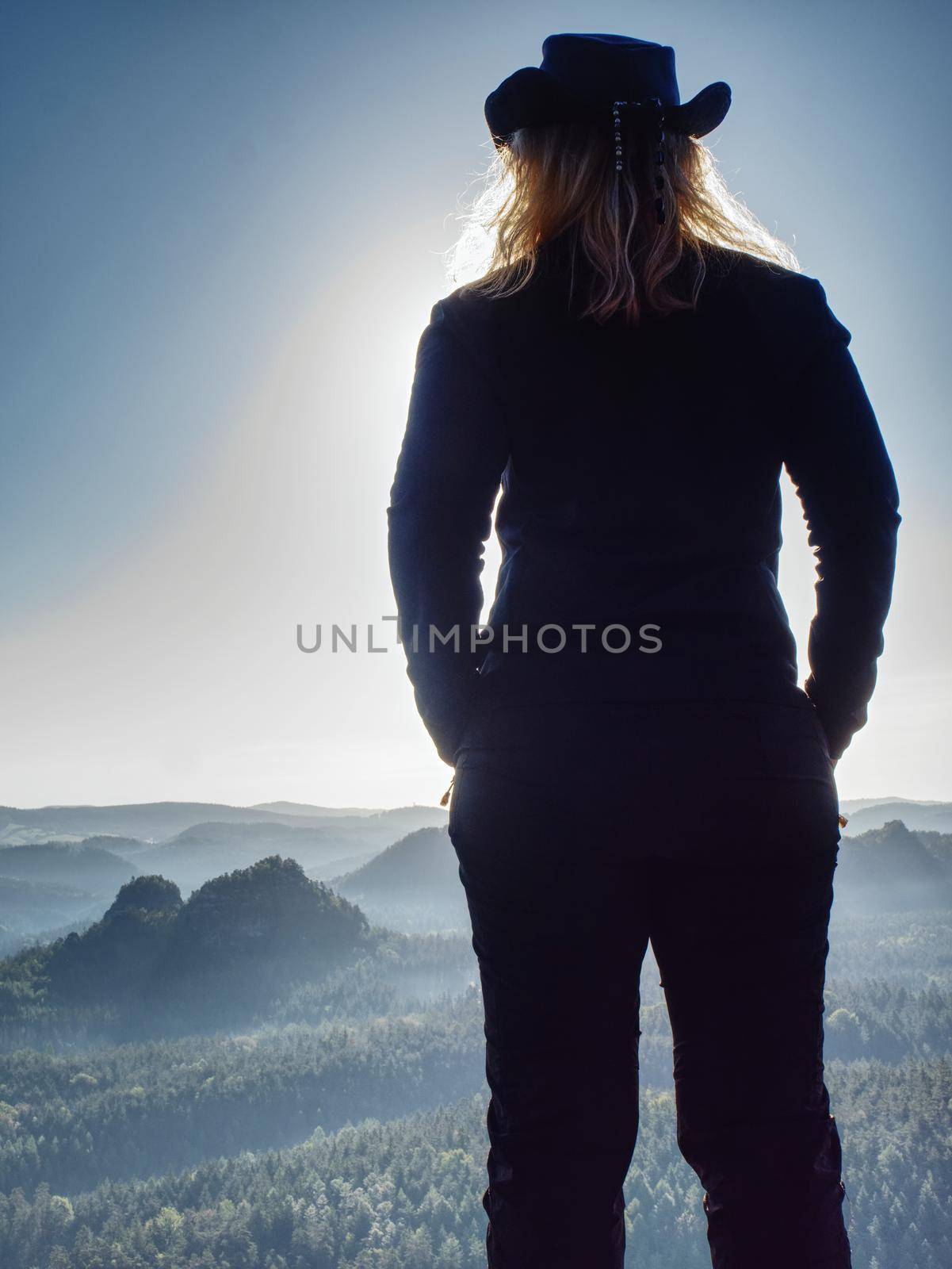 Successful woman cheking the altitude on of sharp cliff edge by rdonar2