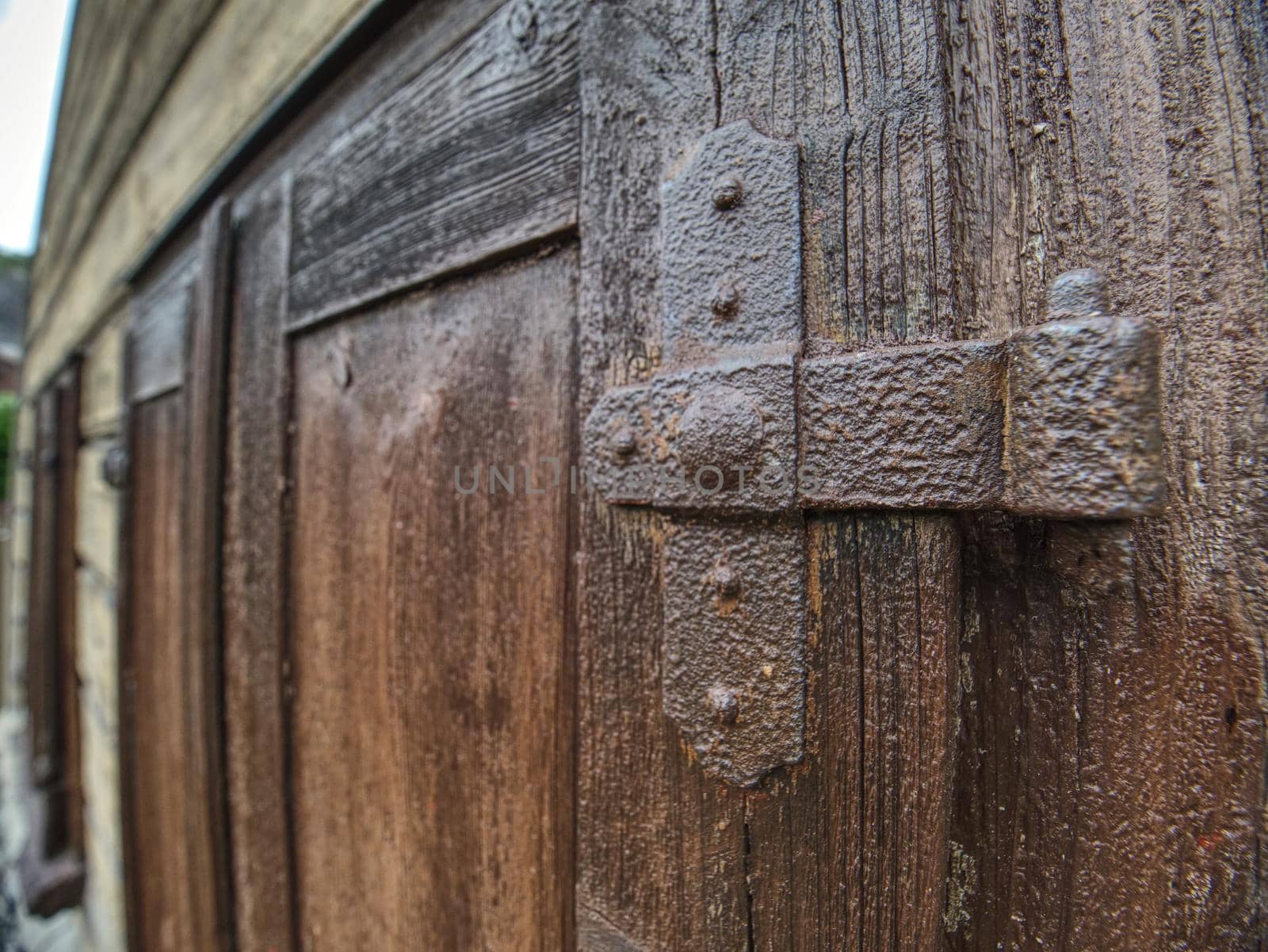 Close up outdoor view of part of ancient closed wooden shutters. Traditional wooden house