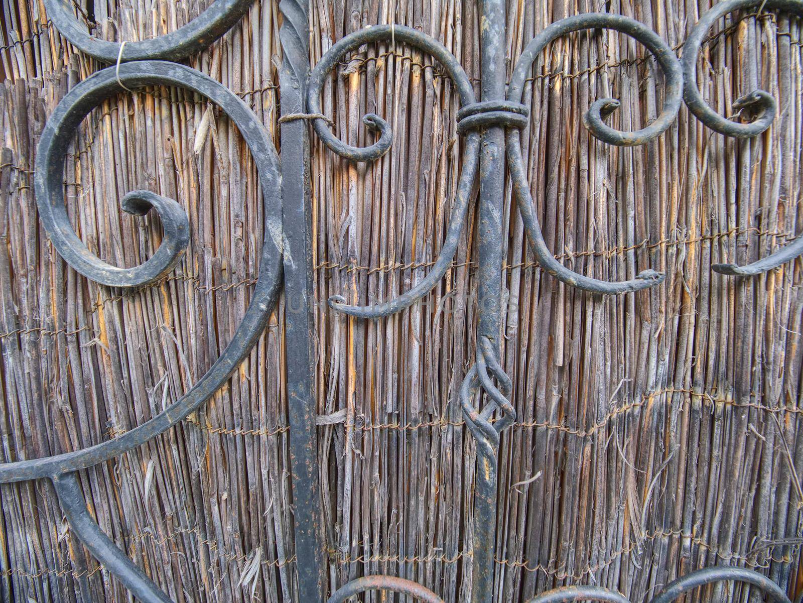 Simple ornaments in fence, wrought-iron gate. Traditional ornamental forging