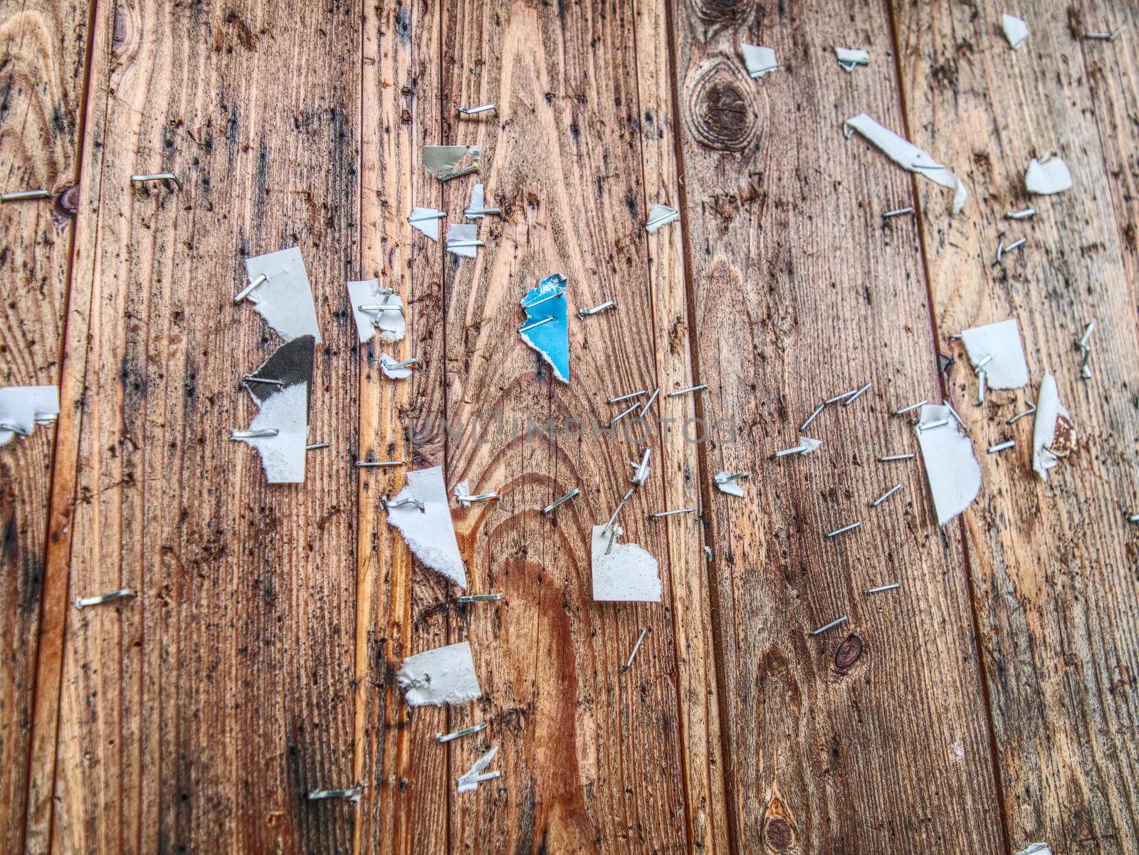 Scraps of paper on a wooden wall or  old wooden fence.  by rdonar2