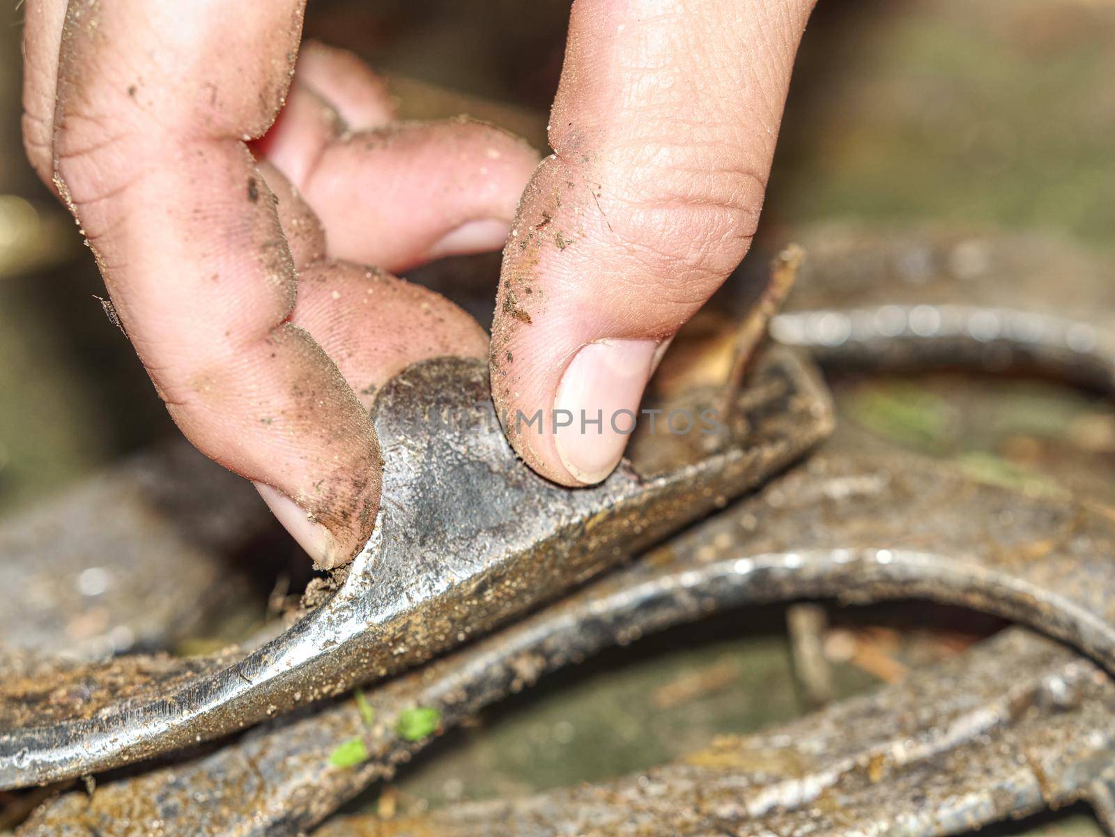 Fingers touch old brushed orthopedic horseshoes by rdonar2