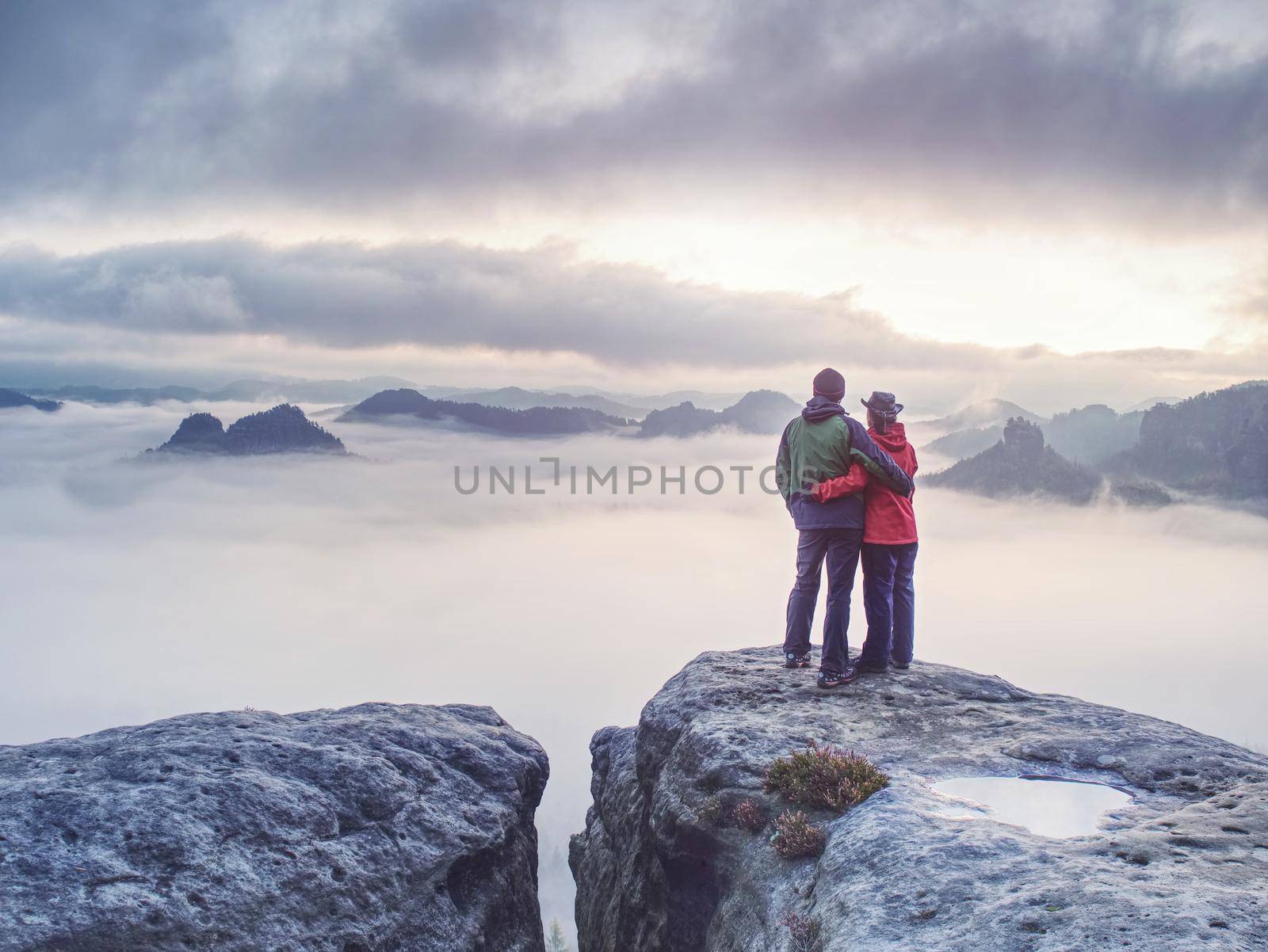Couple with enjoy view after climbing top of rocky mountain by rdonar2