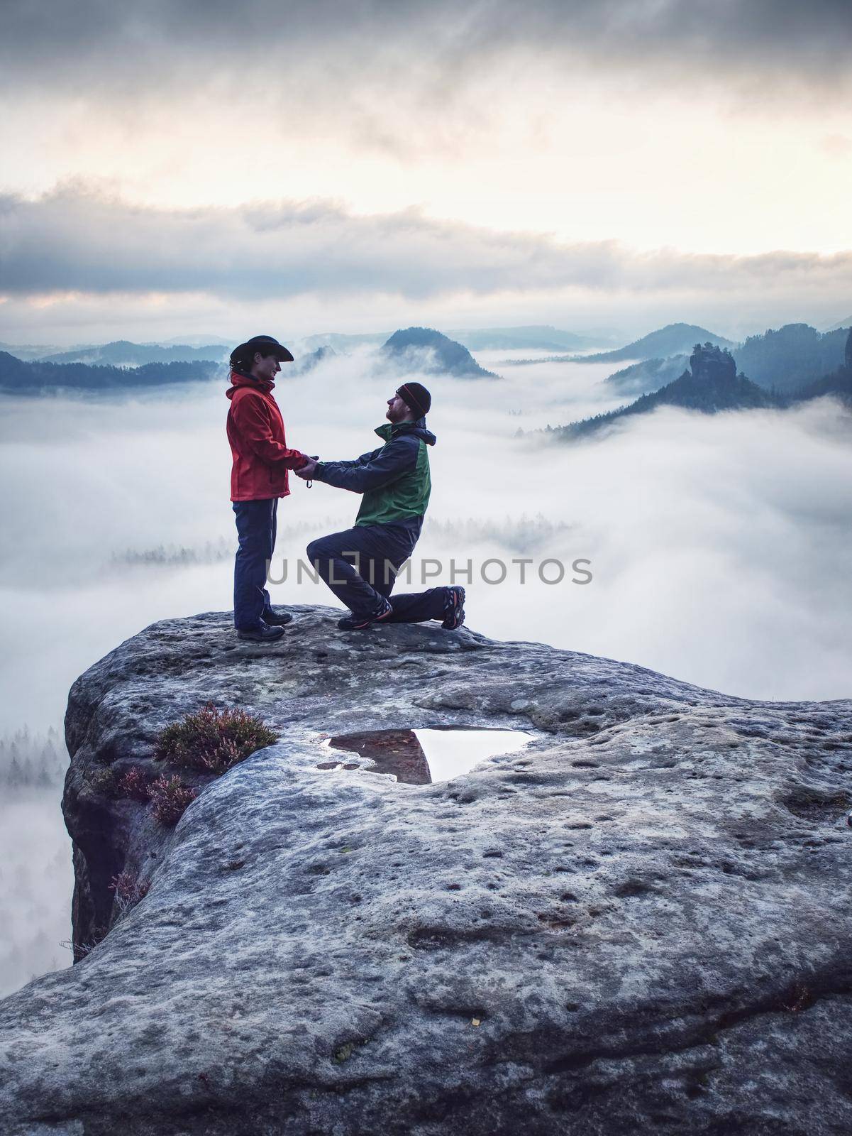 Lover women and men travel together and relax on the mountain with sunrise. Silhouette of lovers. Couple. People relationship