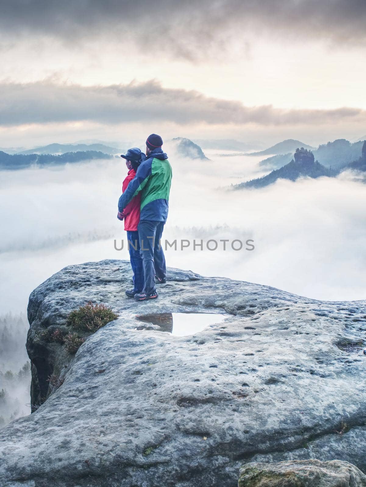 Happy romantic loving hikers couple at misty valley  by rdonar2