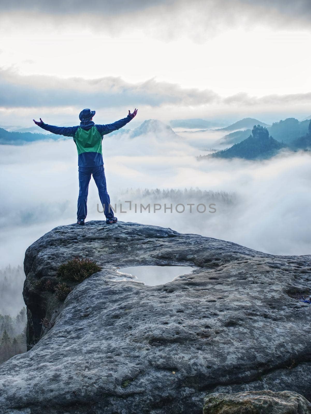 Man finnaly standing on rock and enjoy foggy mountain view  by rdonar2