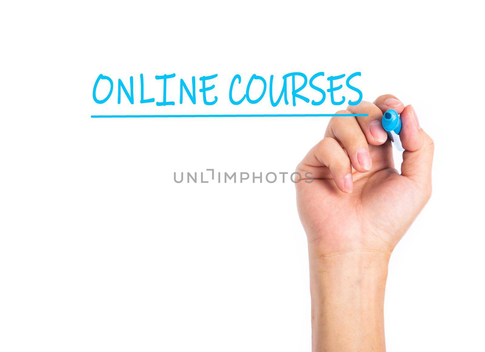 Businessman hand writing ONLINE COURSES on a transparent wipe board.