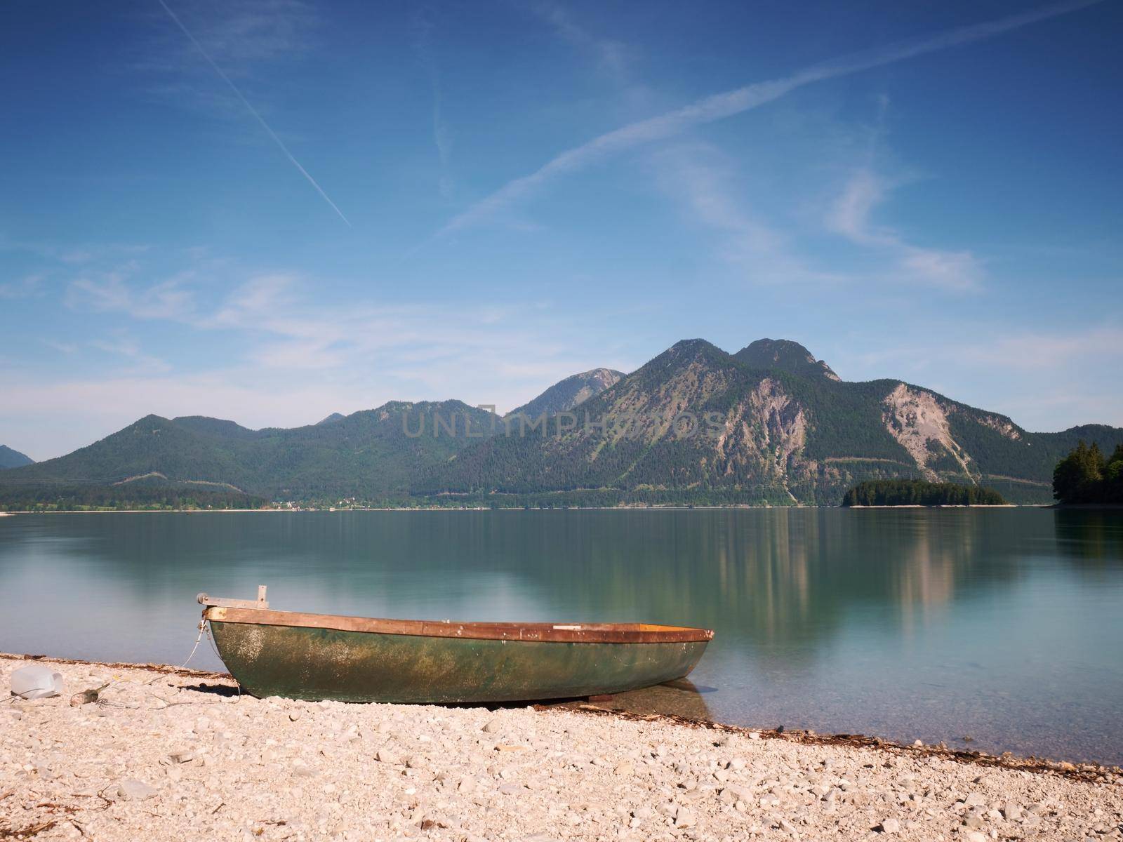 Pebbles  shore of beautiful German mountain lake in remote wilderness.