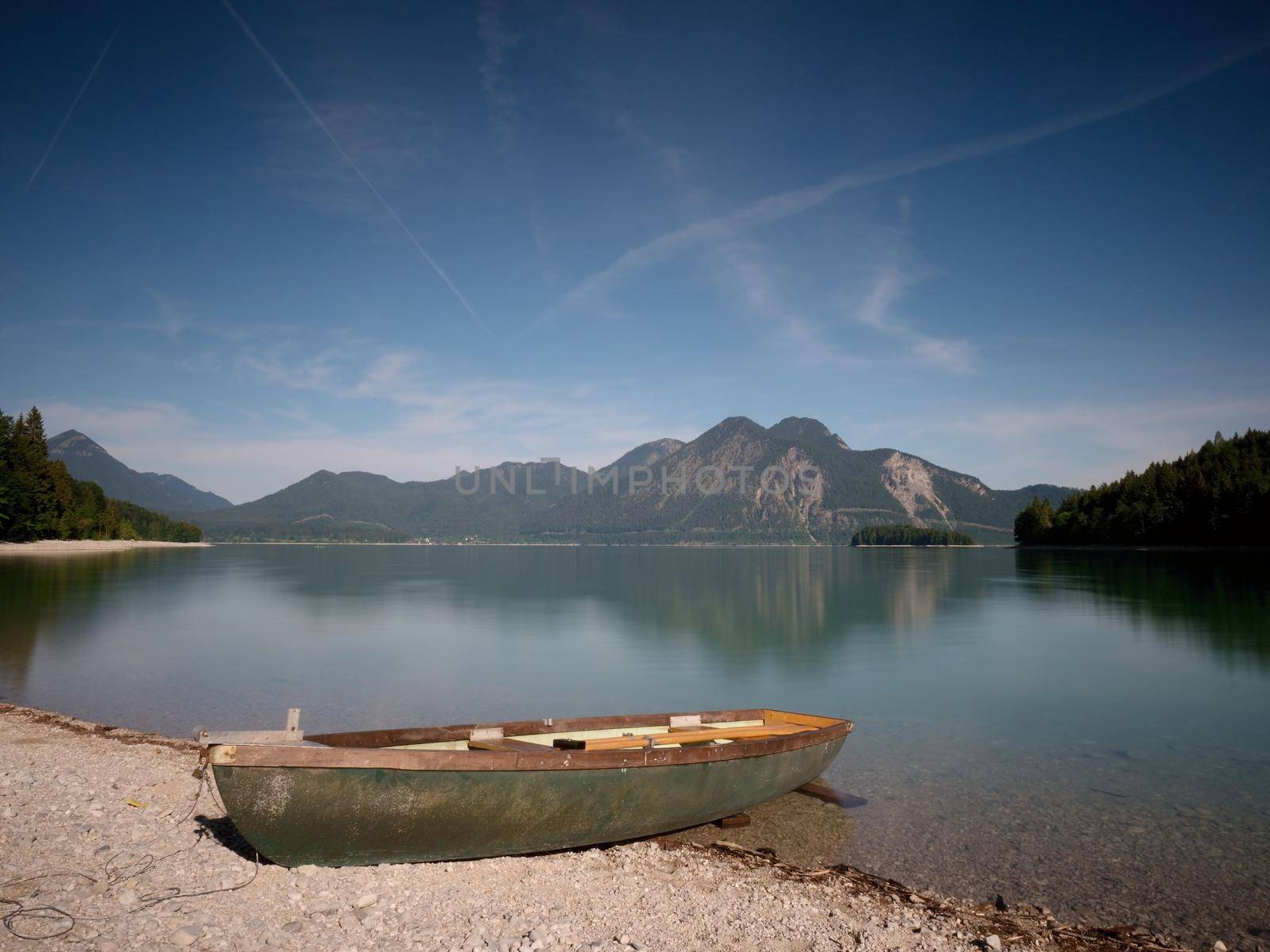 Abandoned fishing boat on bank of Alps lake. Morning lake  by rdonar2