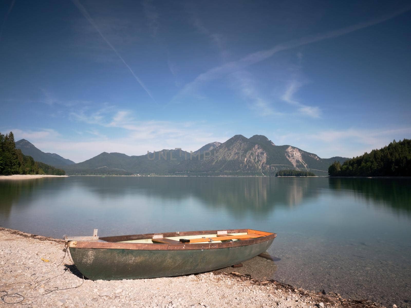 Boat on the stony shore of a mountain lake Walchensee.  by rdonar2