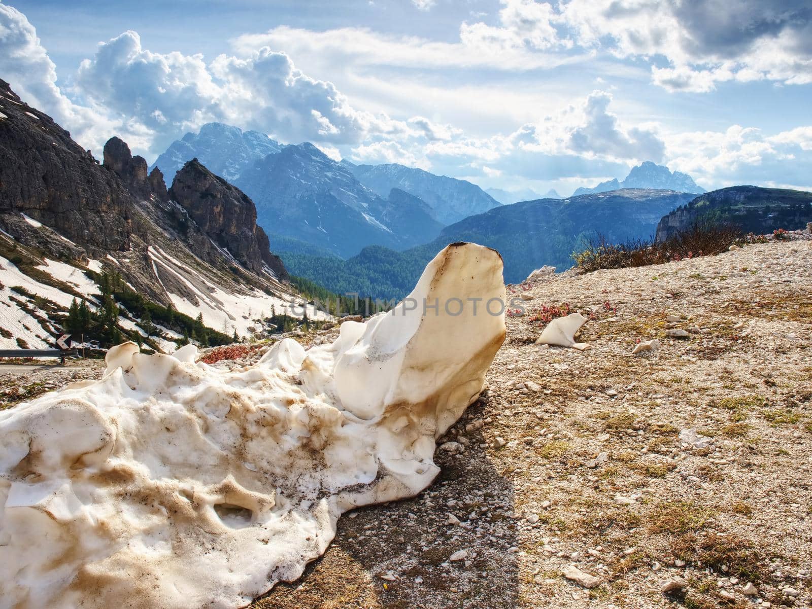 Rest of melting snow at gravel road in spring mountains by rdonar2