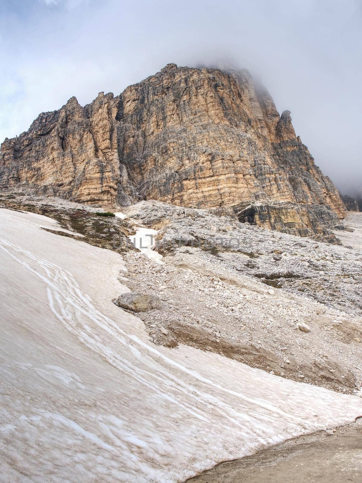 Misty peak of Sasso di Landro,  massive Tre Cime di Lavaredo rocks, Dolomites in Italy