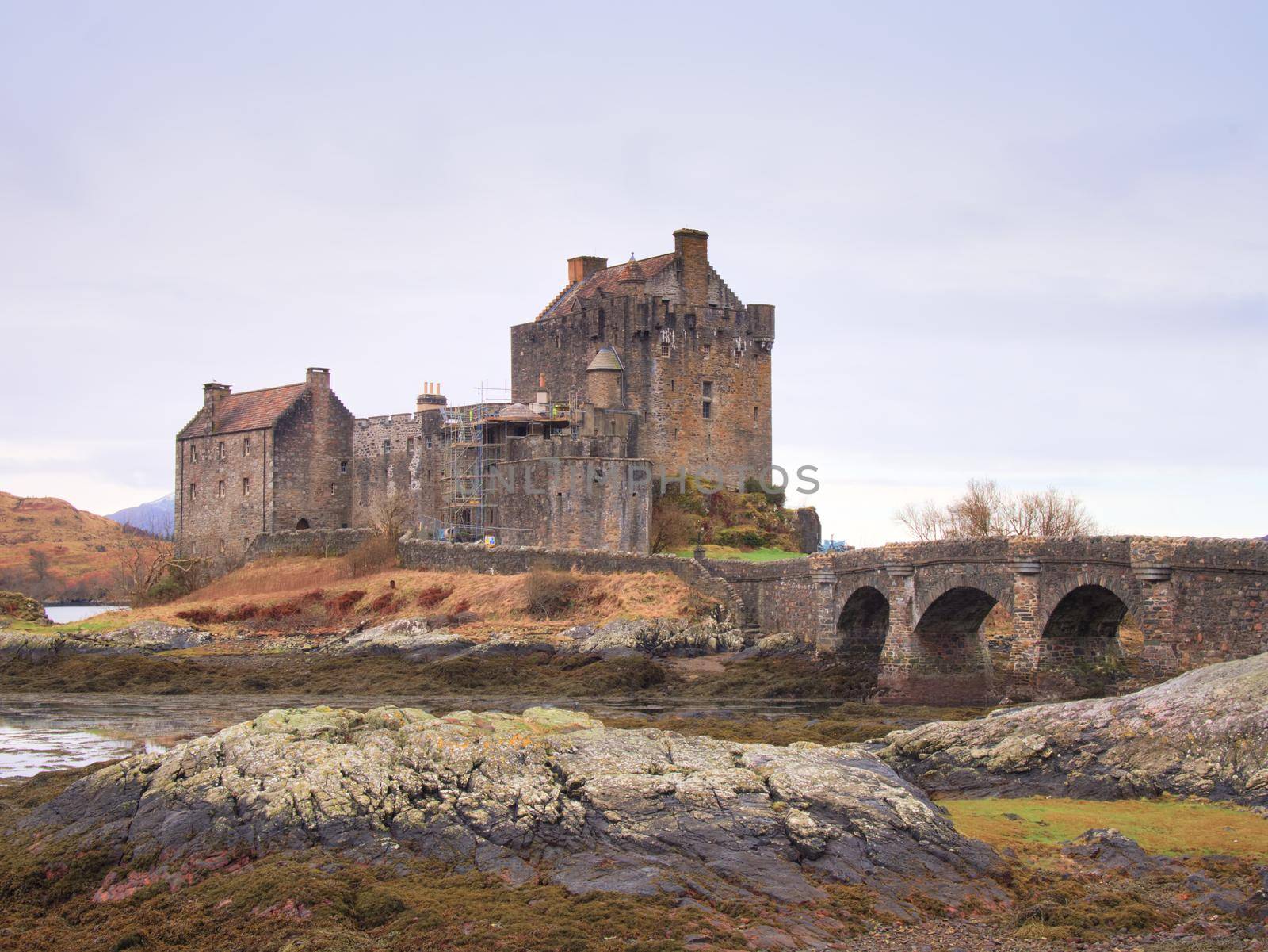 Eilean Donan Castle with a stone bridge above the water,  Scotland,  It was destroyed during the Jacobite rebellions in the early 18th century, and rebuilt