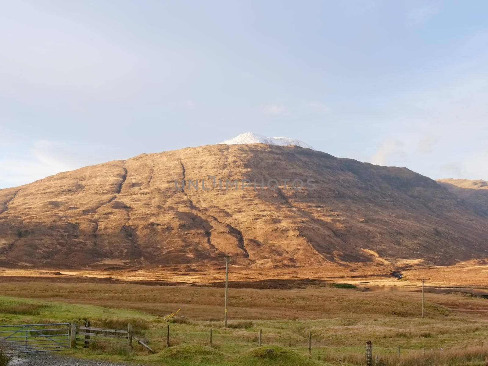 View over  autumnal orange bare landscape, sinle road,  meanders, high  rocky hills  by rdonar2