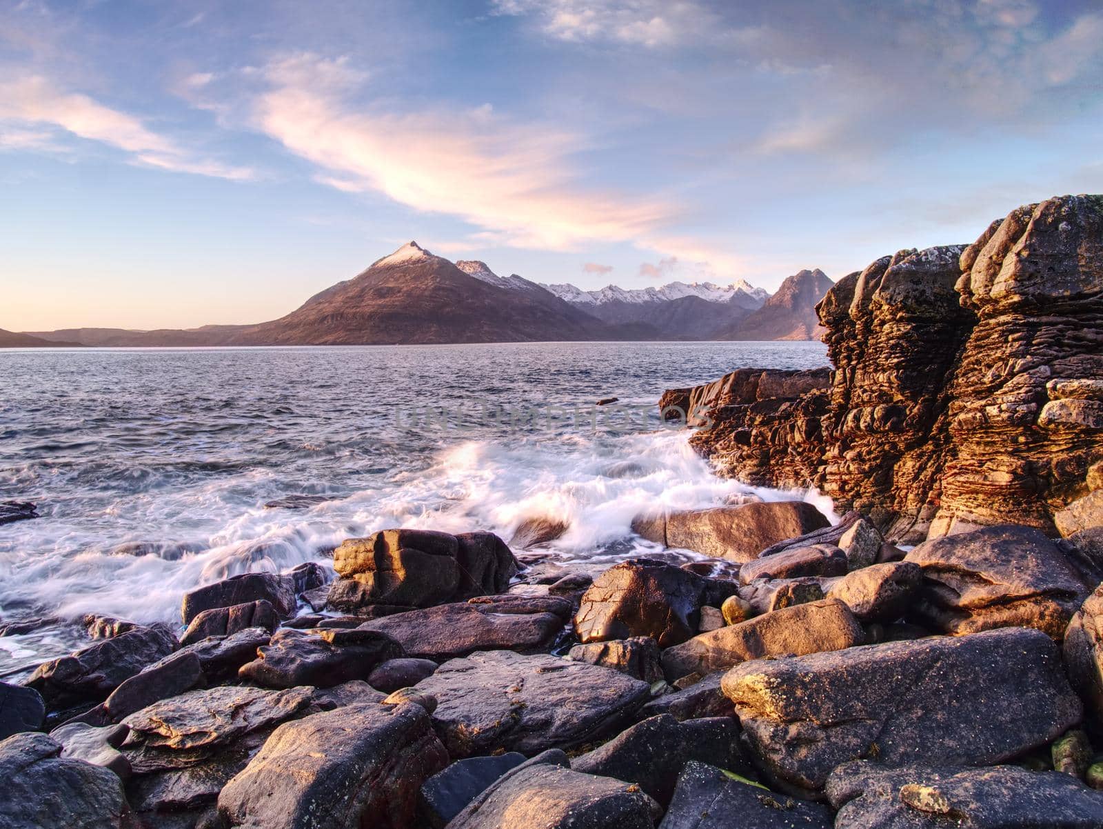 The famous rocky bay of Elgol on the Isle of Skye, Scotland.  The Cuillins  mountain in the background. Photographed at sunset.