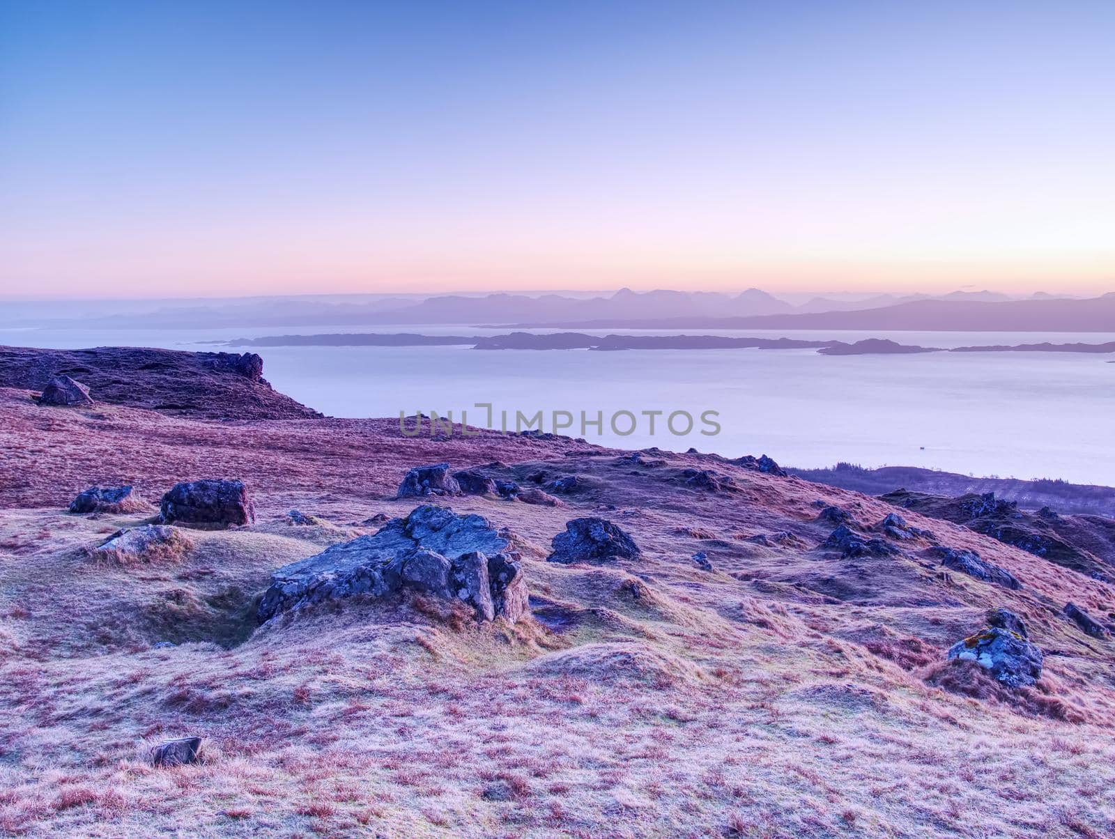 Highland Region Scotland United Kingdom , purople daybreak above sea at horizon