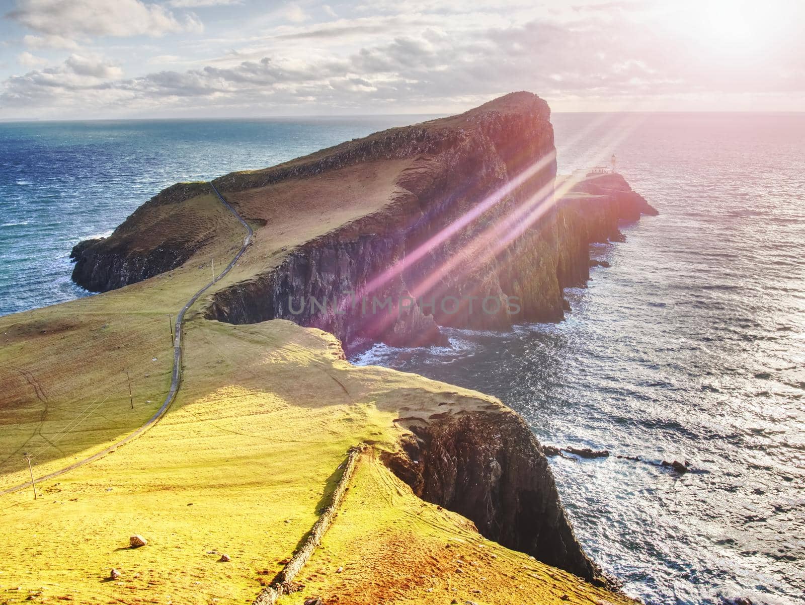 Famous look at Lighthouse on the cliff of Neist Point, rugged and rocky coast on the western side Isle of Skye, Scotland, United Kingdom, Europe