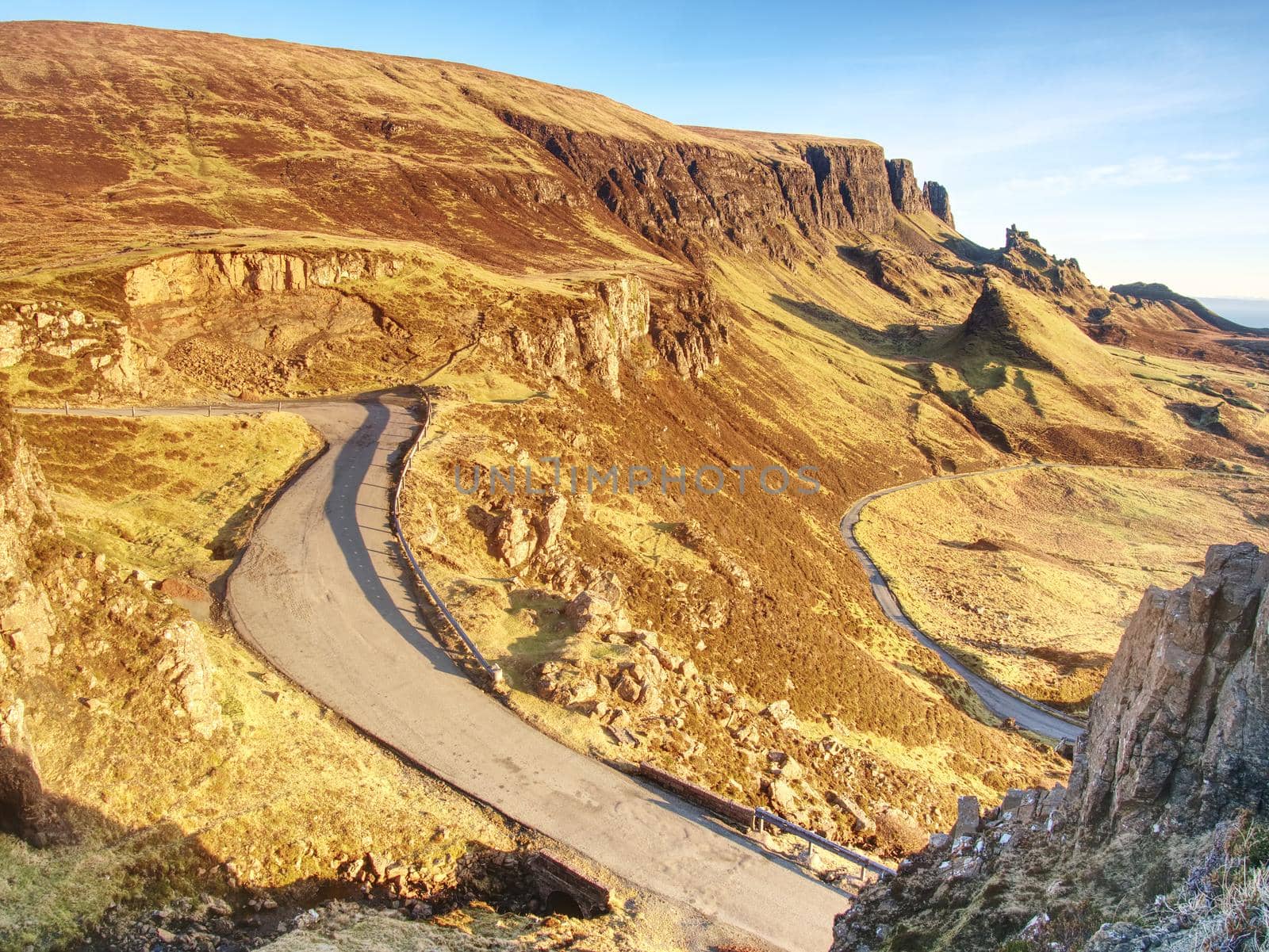 Spring view of Quiraing mountains with blue sky, Isle of Skye. Sharp rocky mountains above vallley. by rdonar2