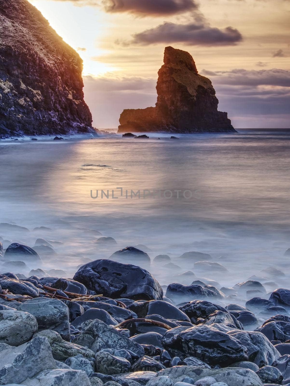 Rocky coast of sea. Slow shutter speed for smooth water level. Visite Talisker Bay on the Isle of Skye in Scotland at sunset