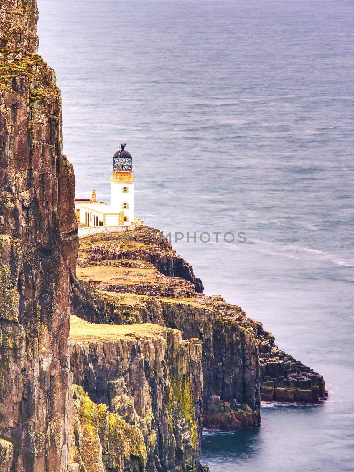 Neist Point peninsula with lighthouse is a very photographed place and tourist attraction on Isle of Skye, Scotland. All travelers must see