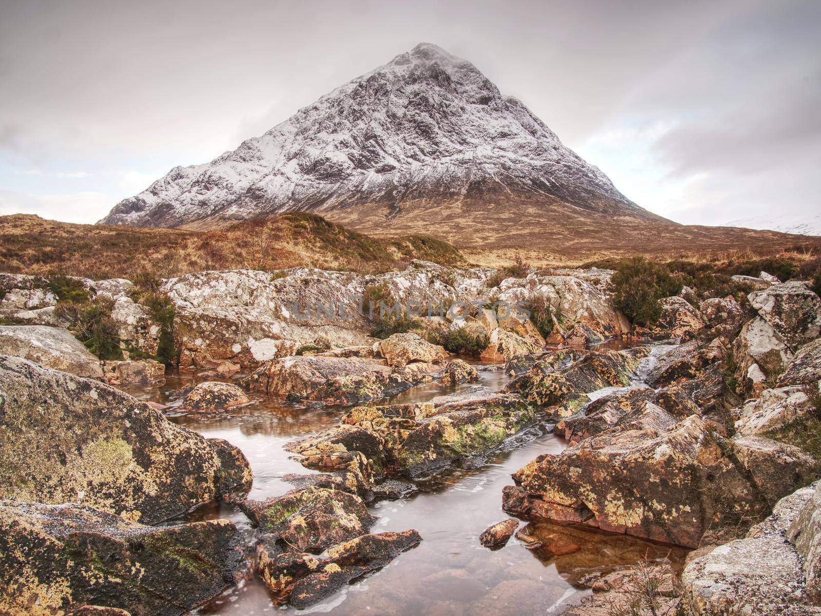 Buachaille Etive Mor alongside the river Coupall near Glencoe in the Scottish highlands.Sunny winter day.