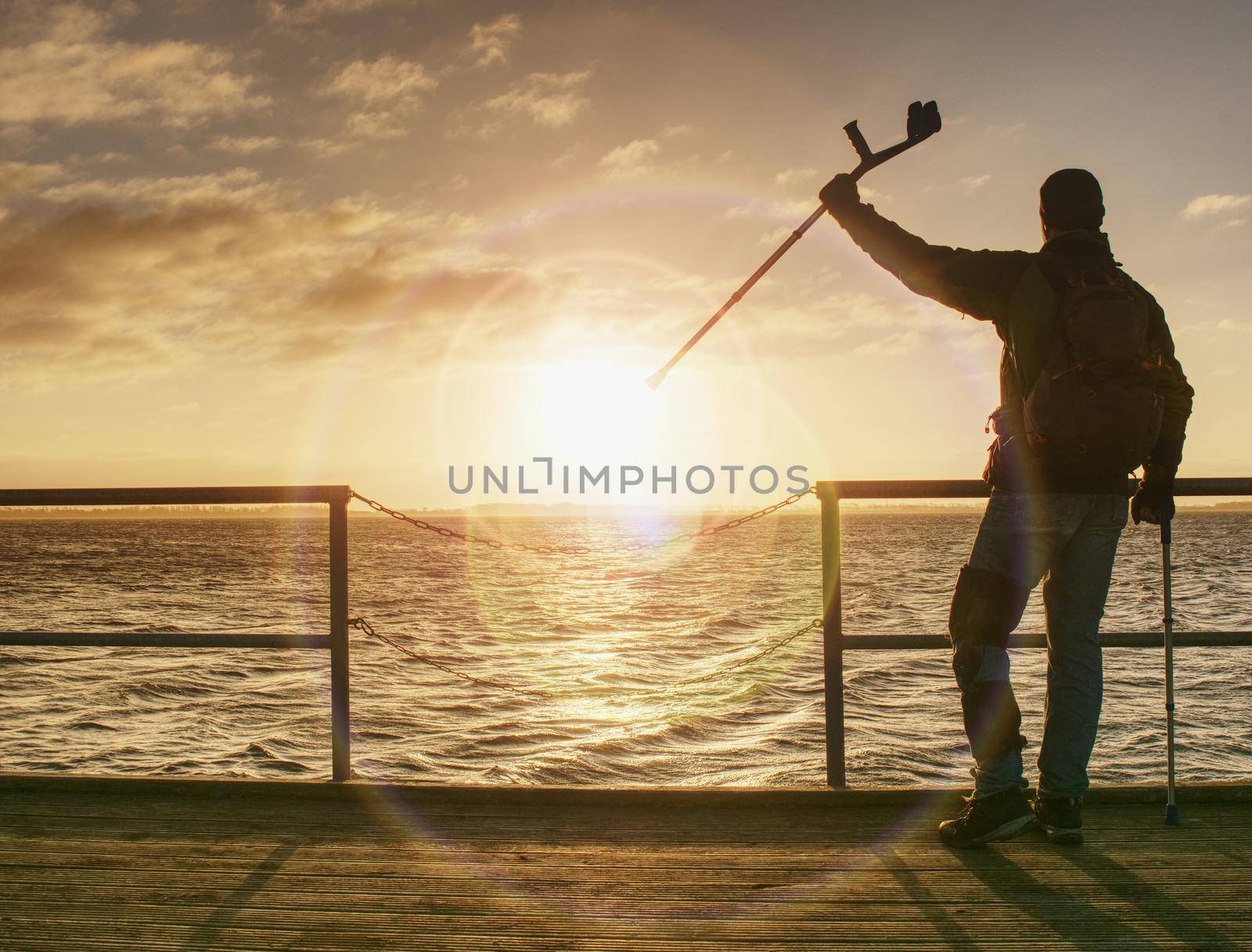 Tourist on ferry boat mole within sunrise or sunset. Warm colors by rdonar2