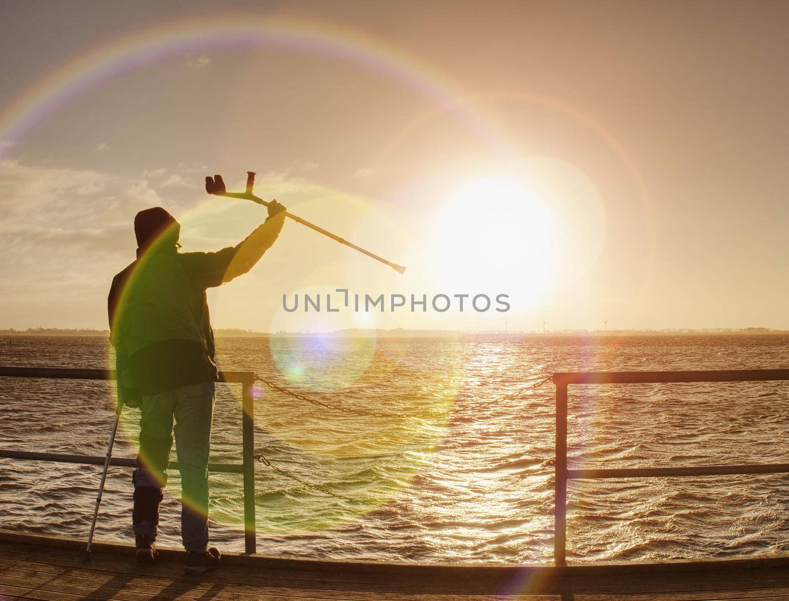 Man lookking over silent sea to horizon. Tourist in harbor