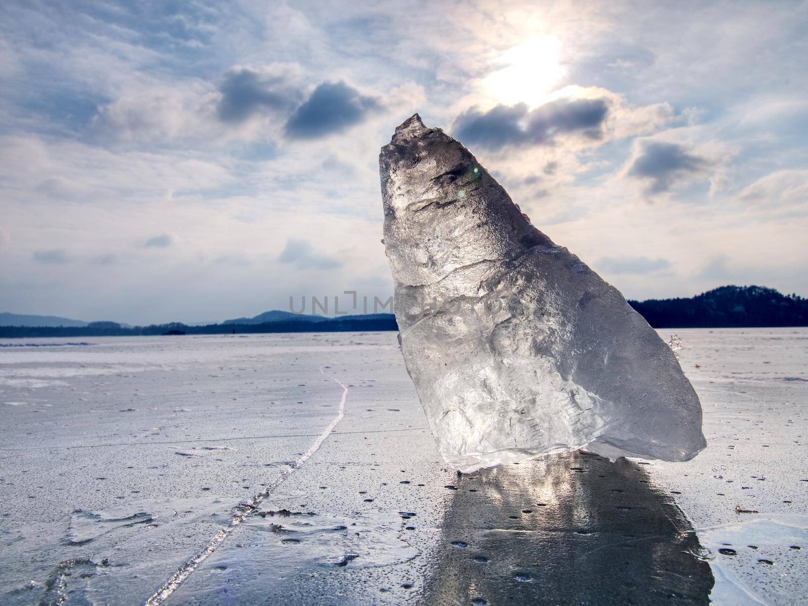 Iceberg or ice piece on large floe. Sharp ice that has broken off a glacier or an ice shelf  floating freely in open sea