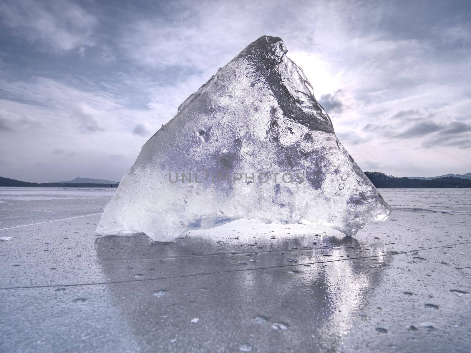 Arctic cold landscape of icy lake at sunset with cracks and patterns  by rdonar2