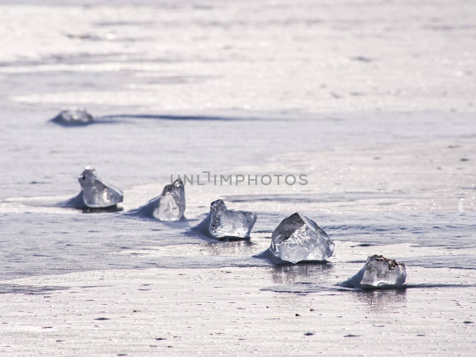Transparent ice block on  frozen sea surface. Amazing Sun  reflection by rdonar2
