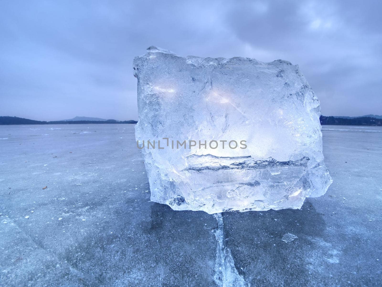 Natural ice blocks. Ice floe breaking due to strong wind against the shore and move. Freezing winter weather.