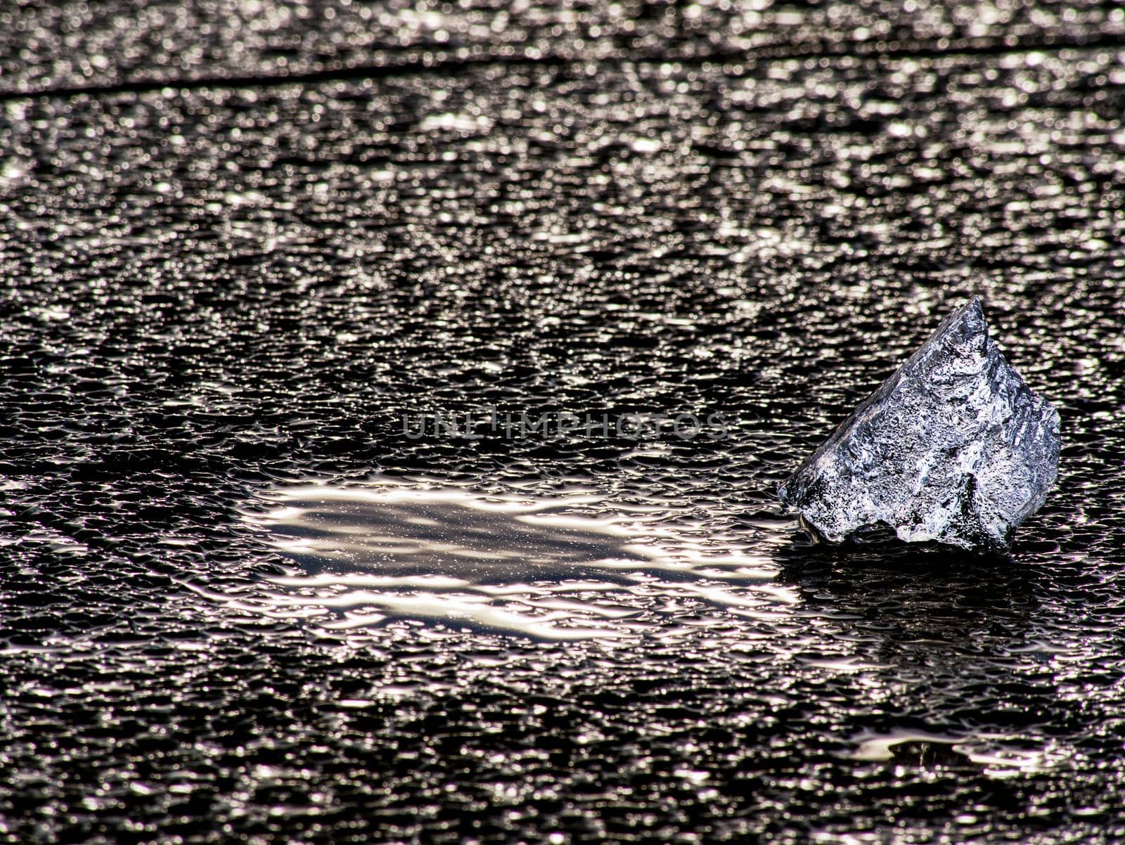 Ice fragments on the lake. Flat surface of  frozen lake. Kra, ice on the water surface. Season of the early spring.