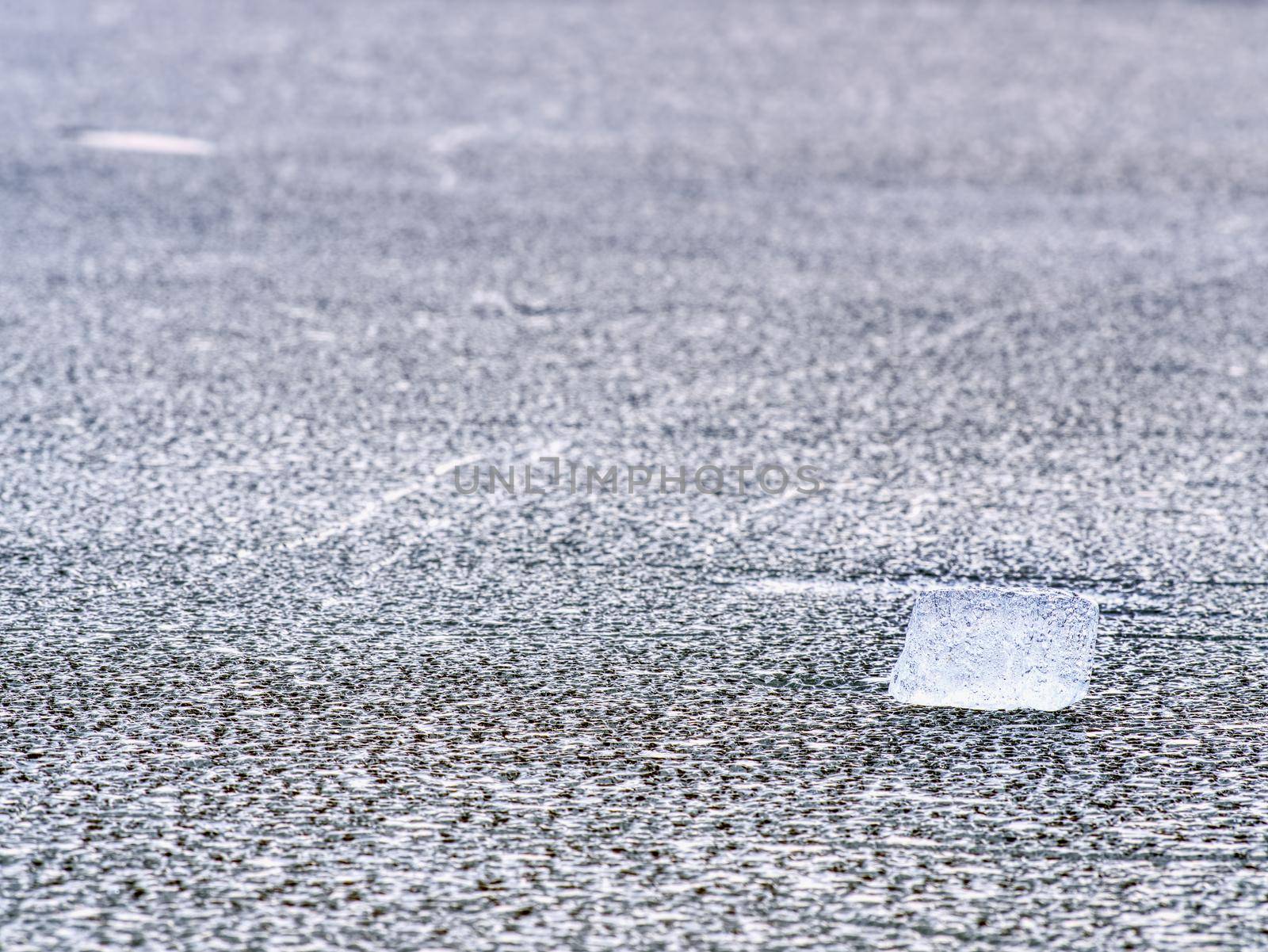 Cracked glacier ice in close-up detail. Natural ice pattern structure with natural baackground. Winter detail