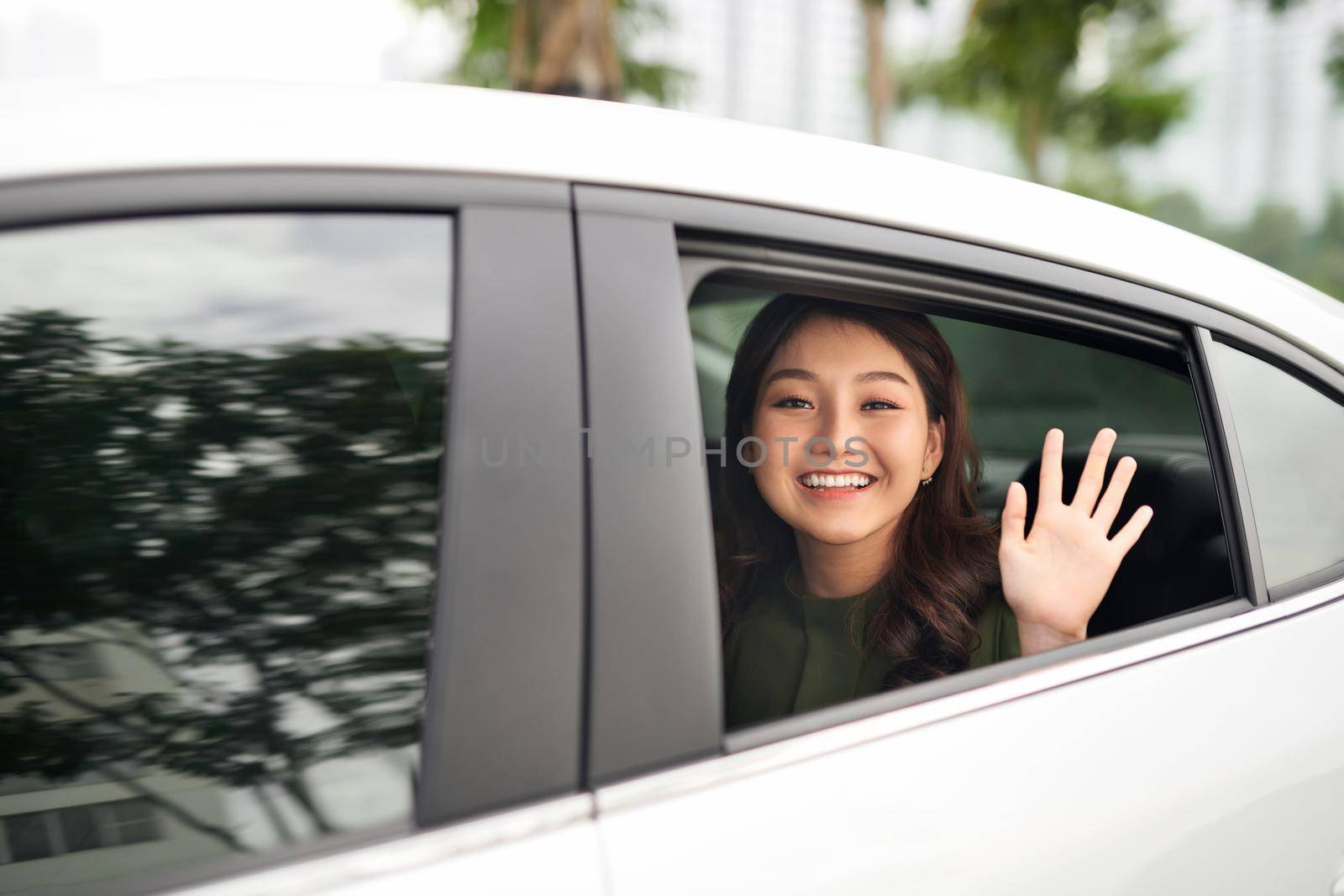 Woman in car. Beautiful young woman looking out from a car and looking at camera
