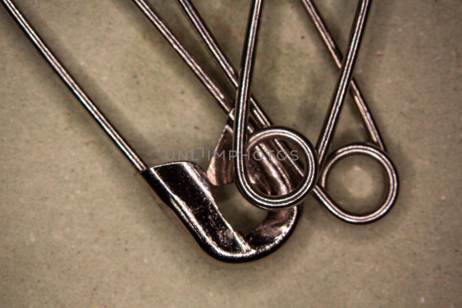 metallic safety pins in close-up
