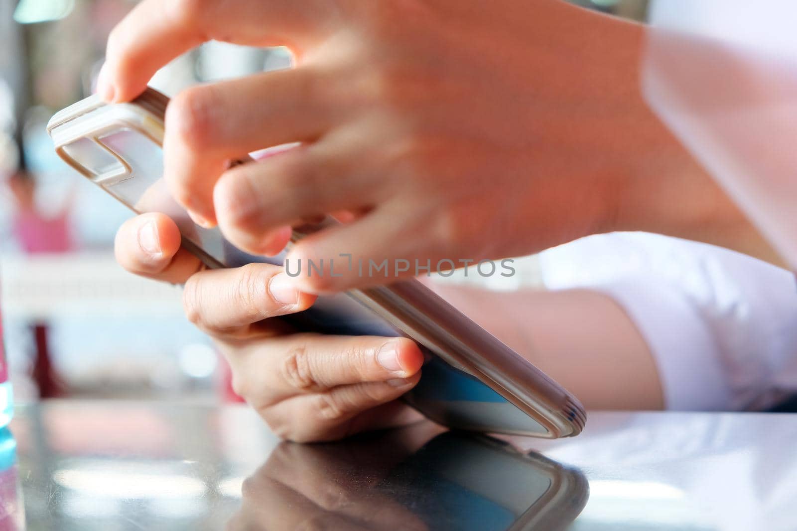 close up image of Teenage girl text messaging on her phone