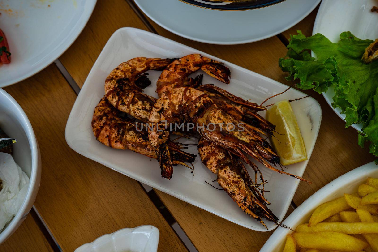 Grilled shrimps on the plate by Elet