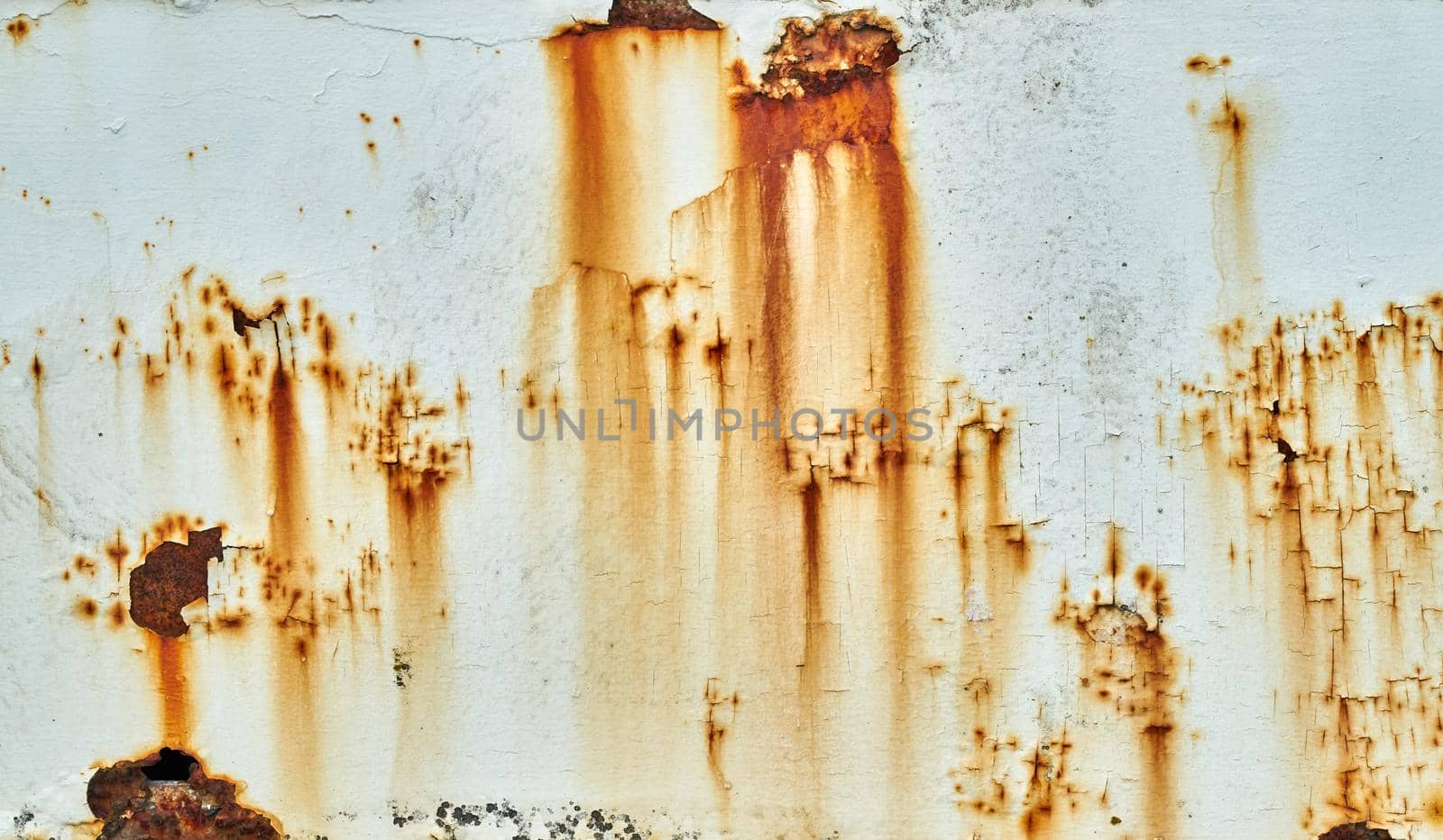 Patches of rust and peeling paint on a white wall by ChrisWestPhoto