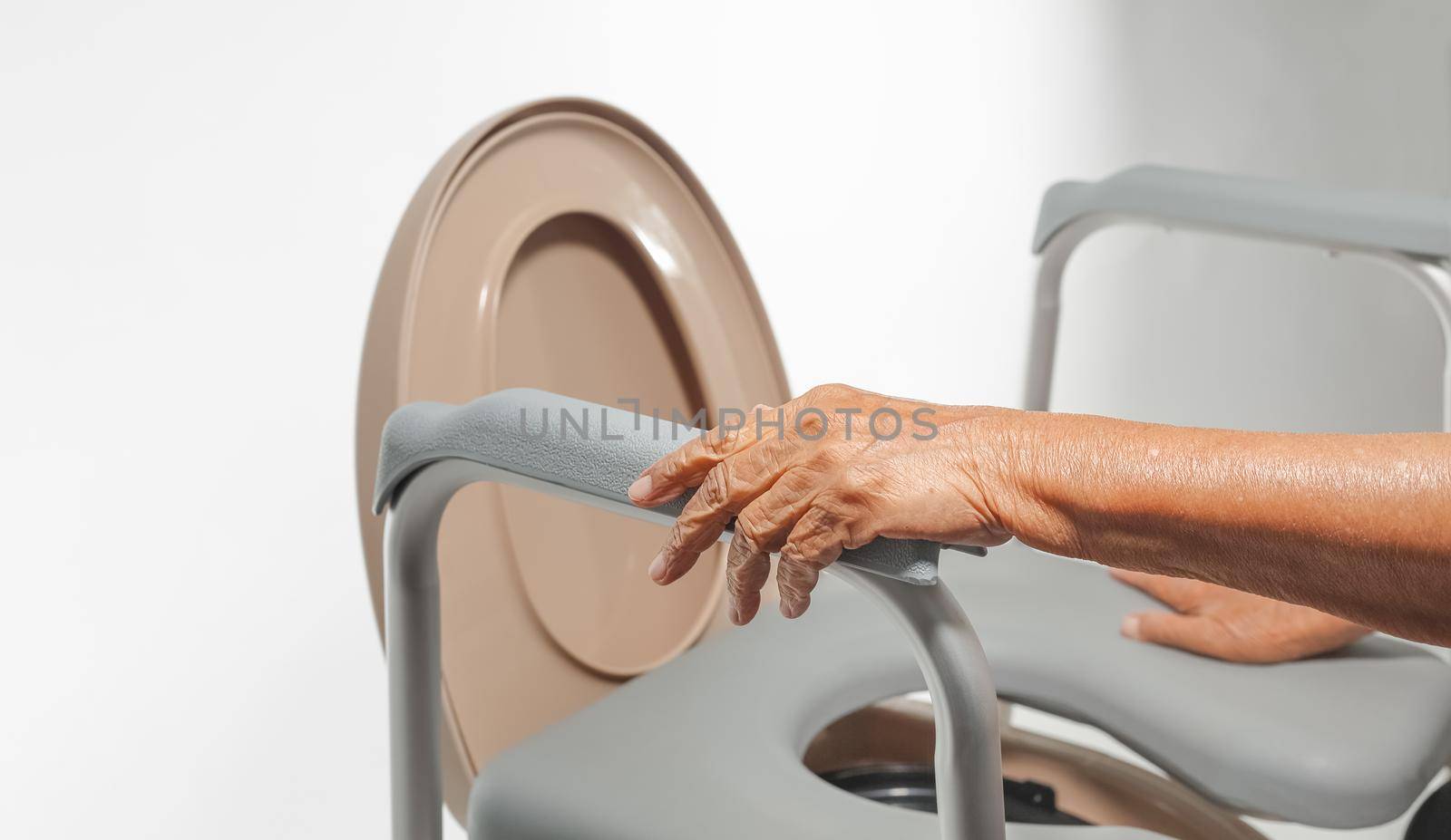 Elderly woman using mobile toilet seat chair by toa55