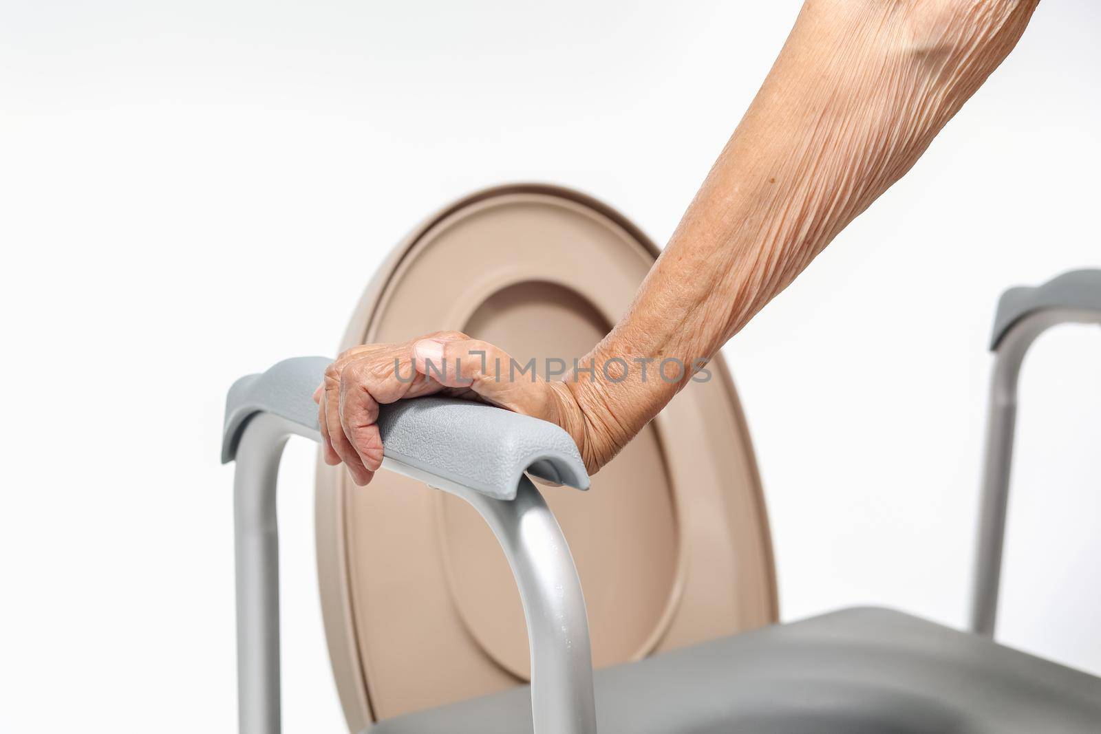 Elderly woman using mobile toilet seat chair