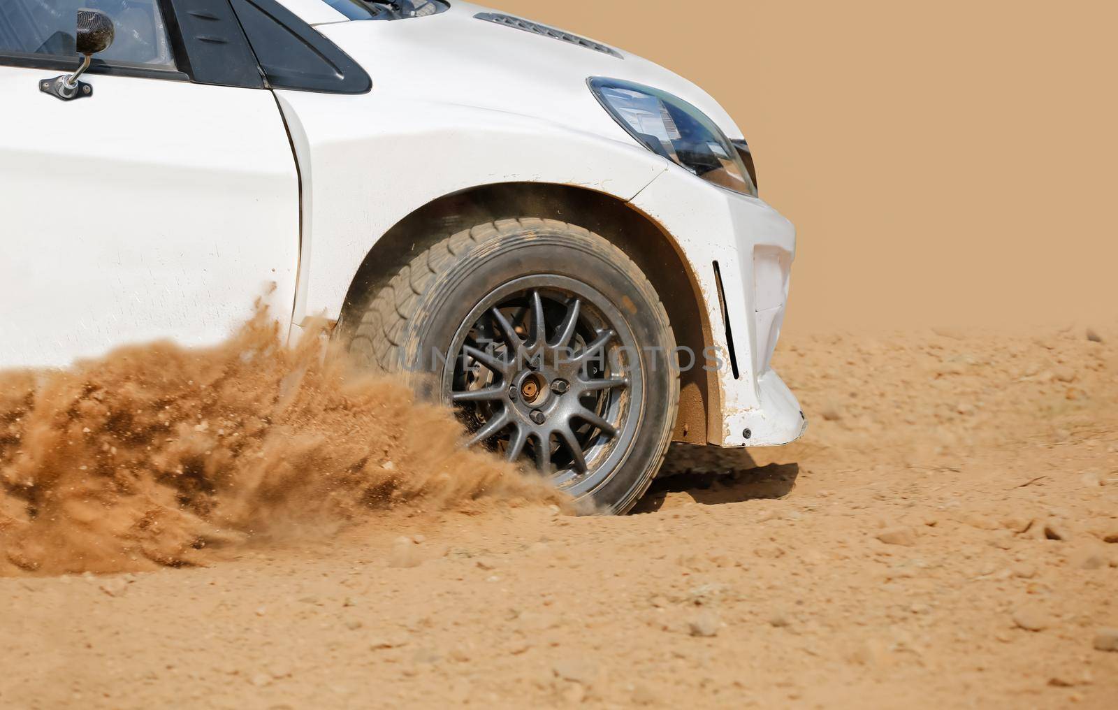 Rally racing car on dirt track.