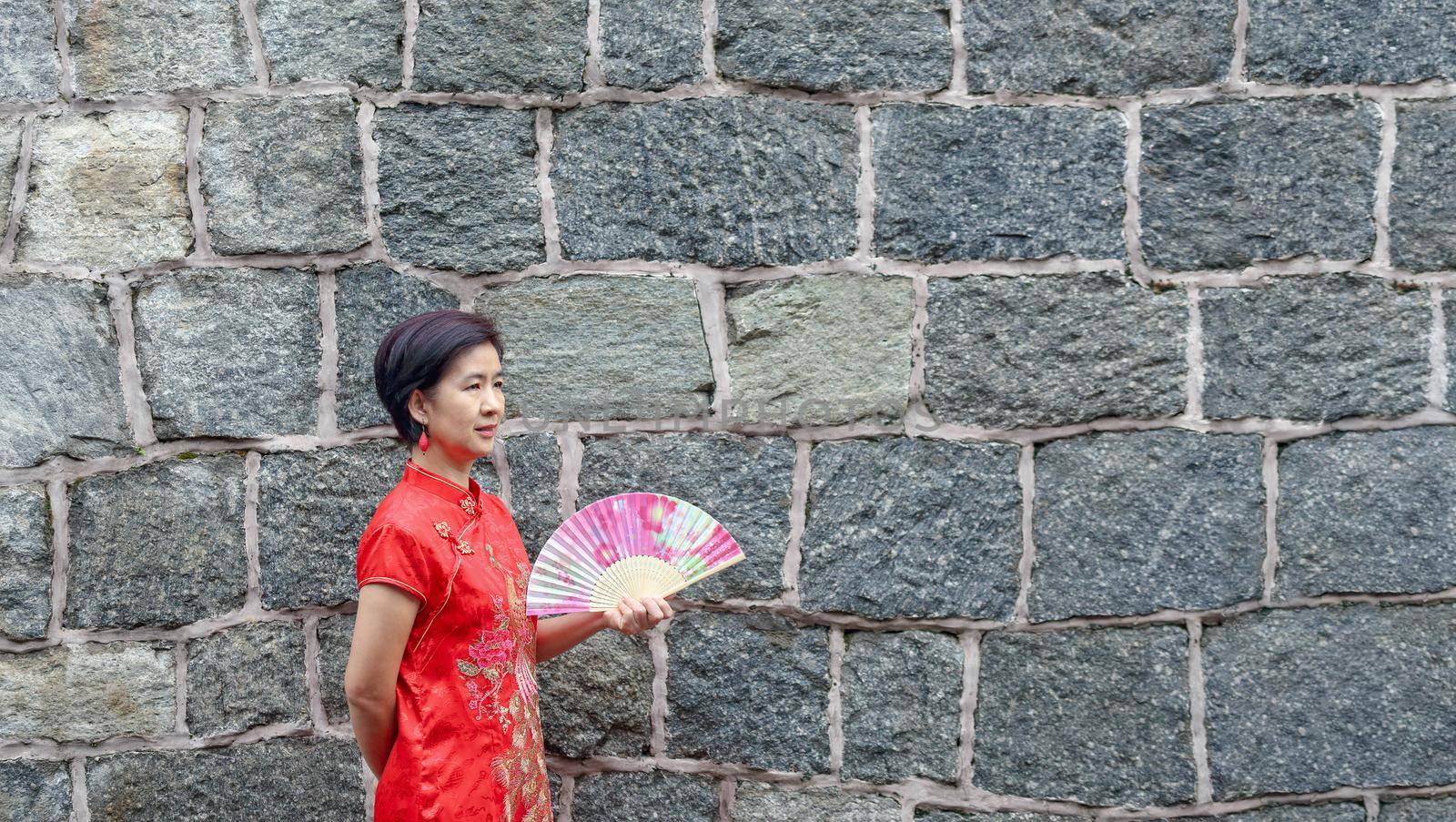 Solo female tourist in chinese traditional clothing with stone wall by toa55