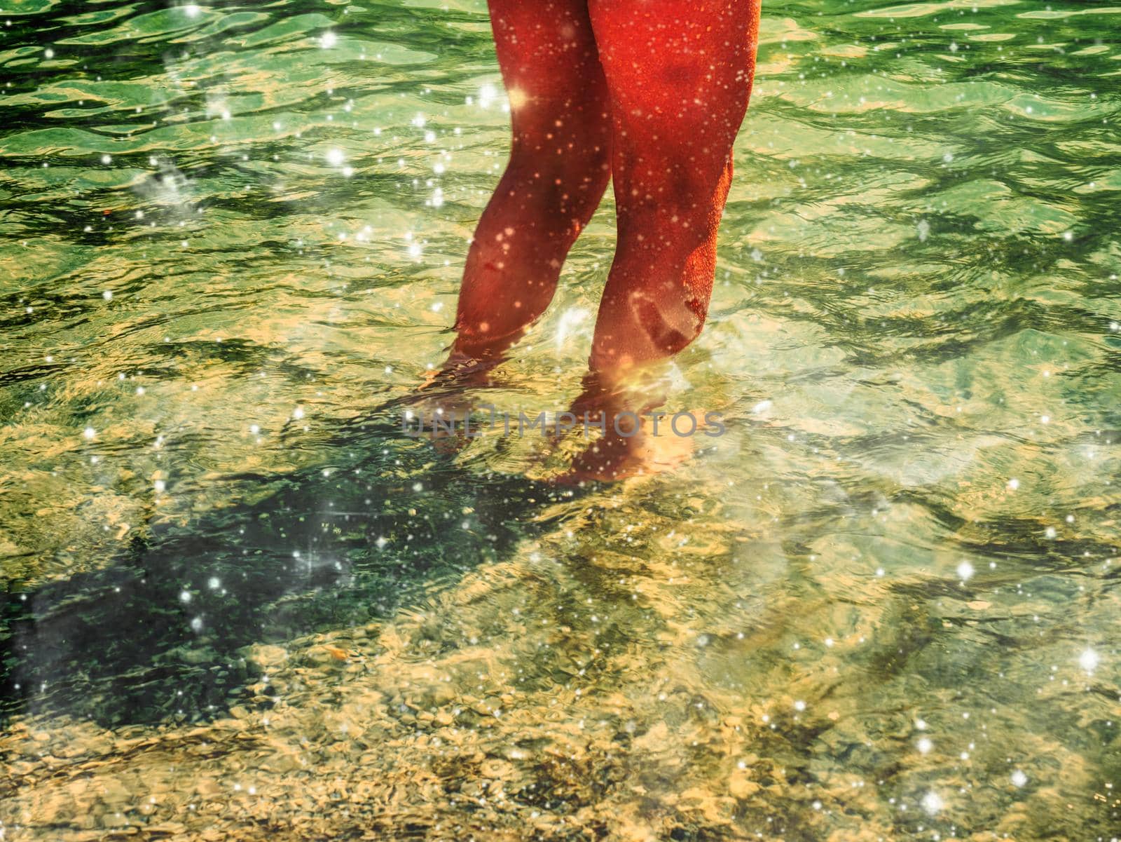 Bare foot legs in the crystalline water in the summer.  Abstract.