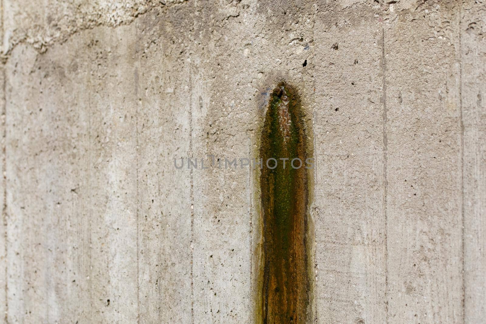 Weeping hole with slurry stain on a concrete retention wall. Close-up. by z1b